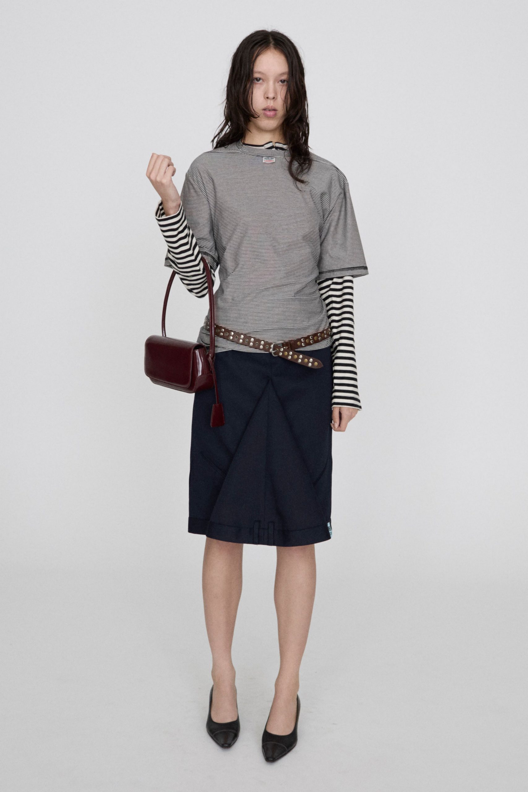 gray t-shirt with striped shirt and navy skirt