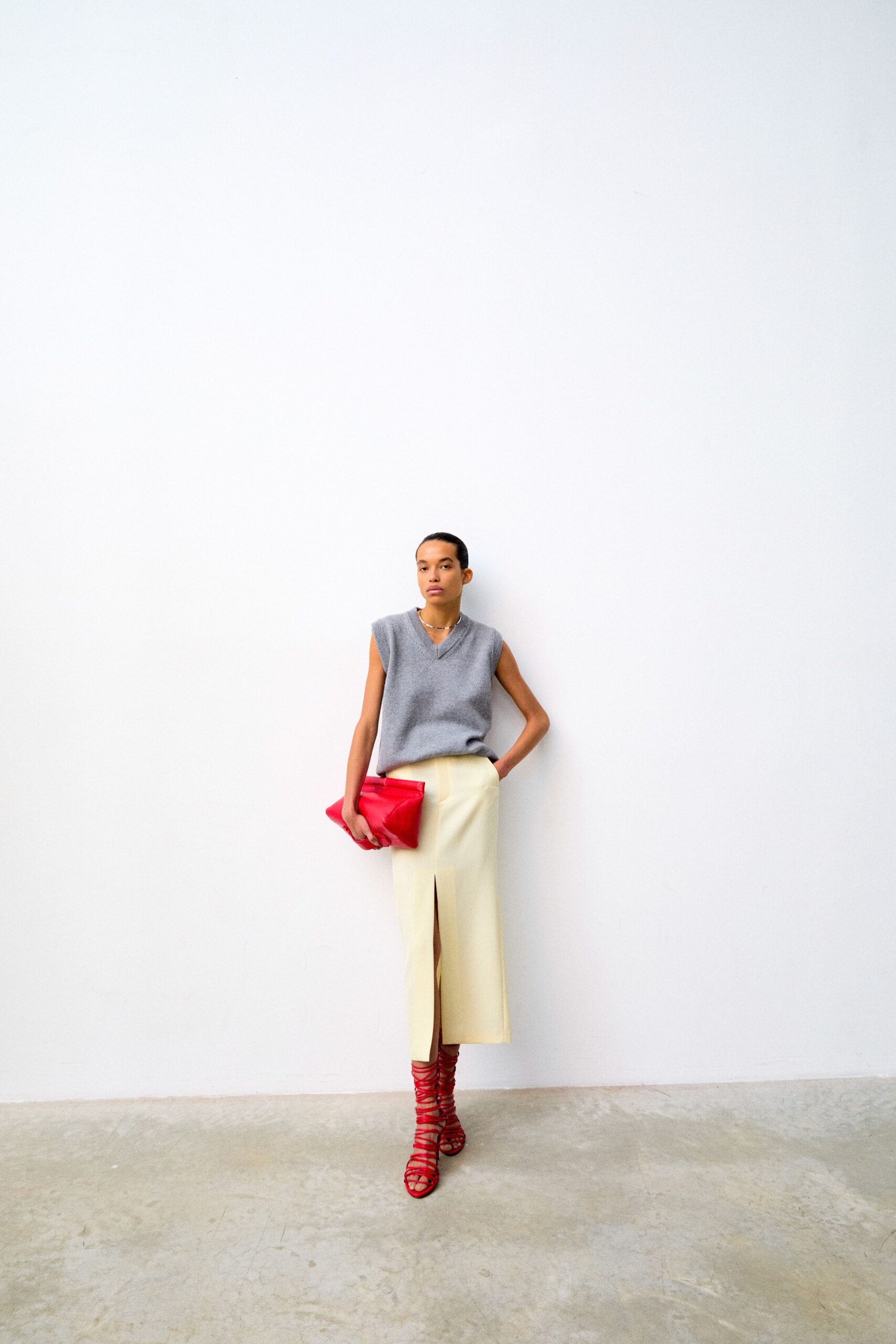 gray wool sleeveless top and white skirt