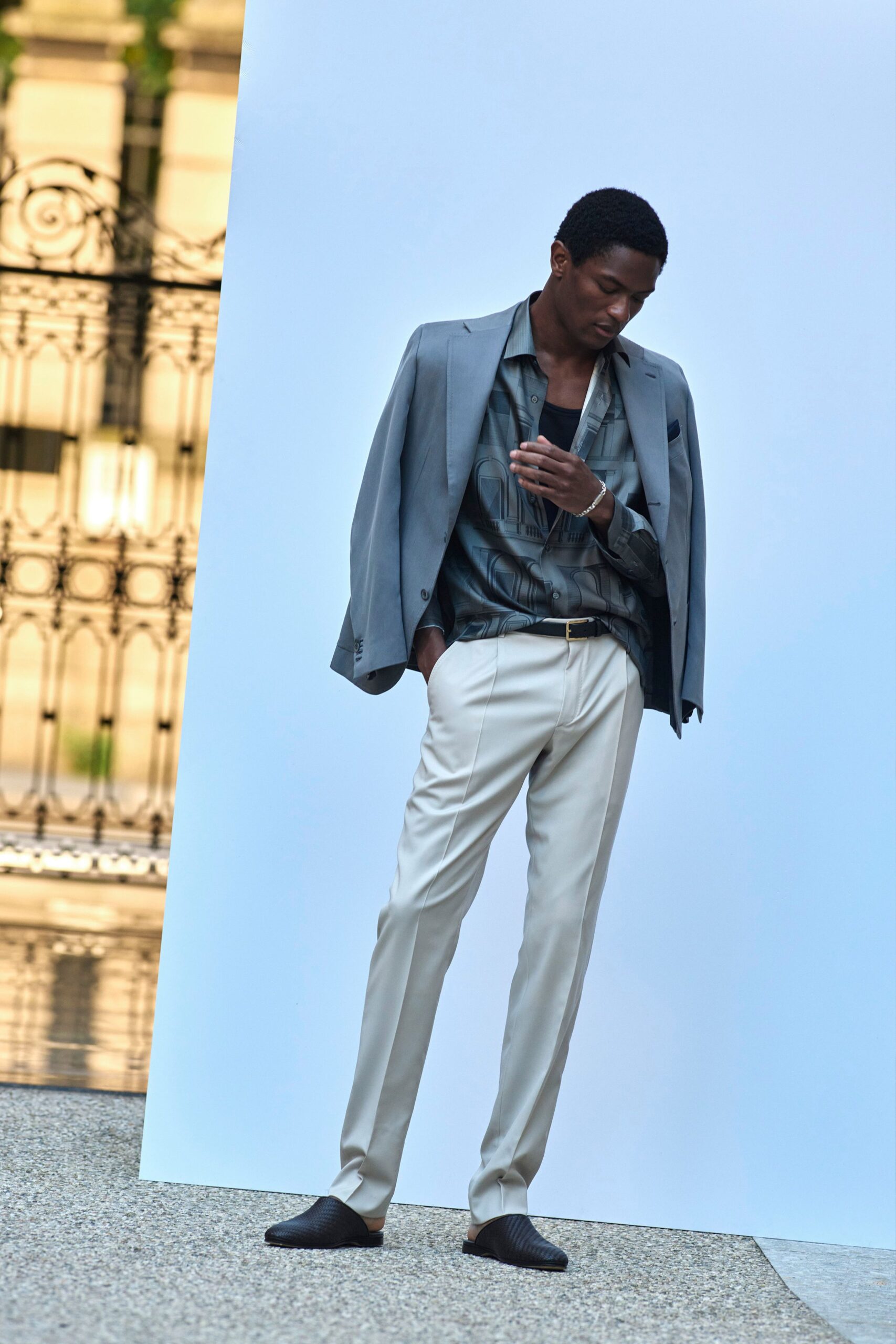 gray blazer black shirt beige pants