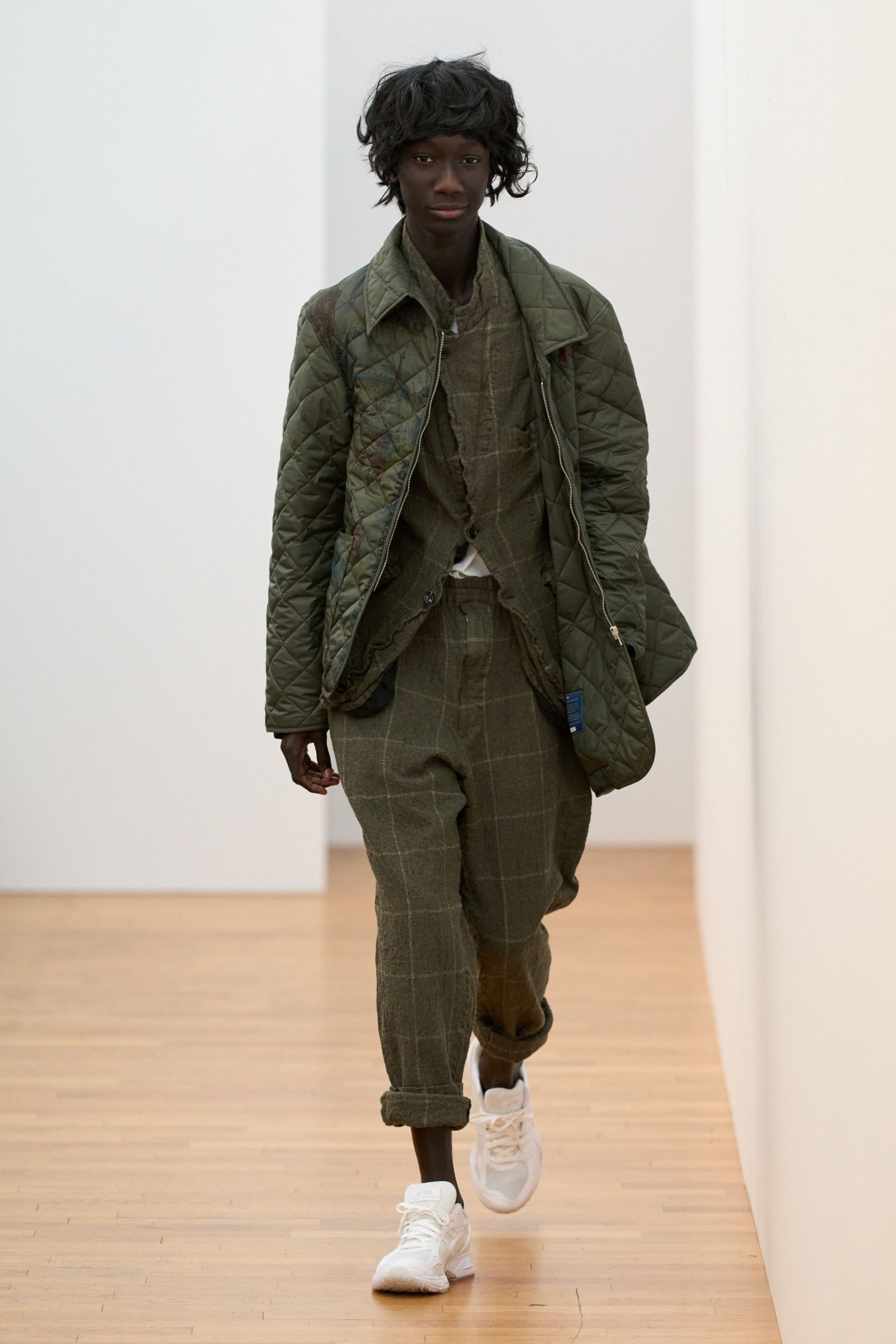 green quilted jacket with checked shirt and pants