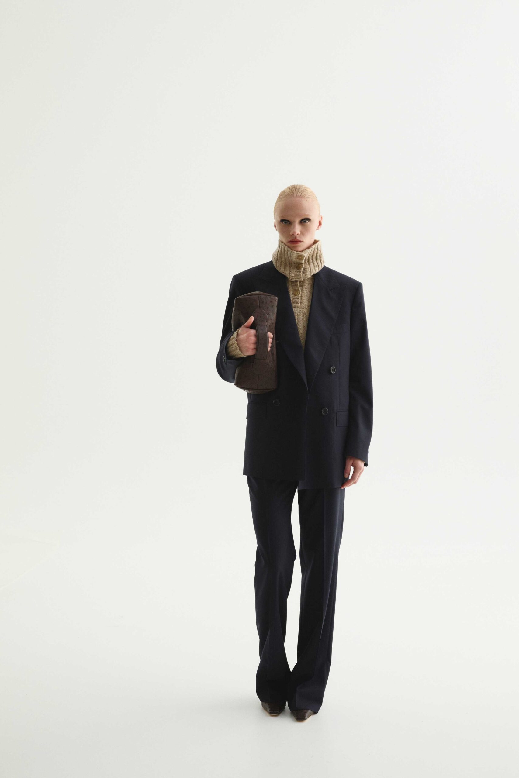 black tailored blazer with beige turtleneck