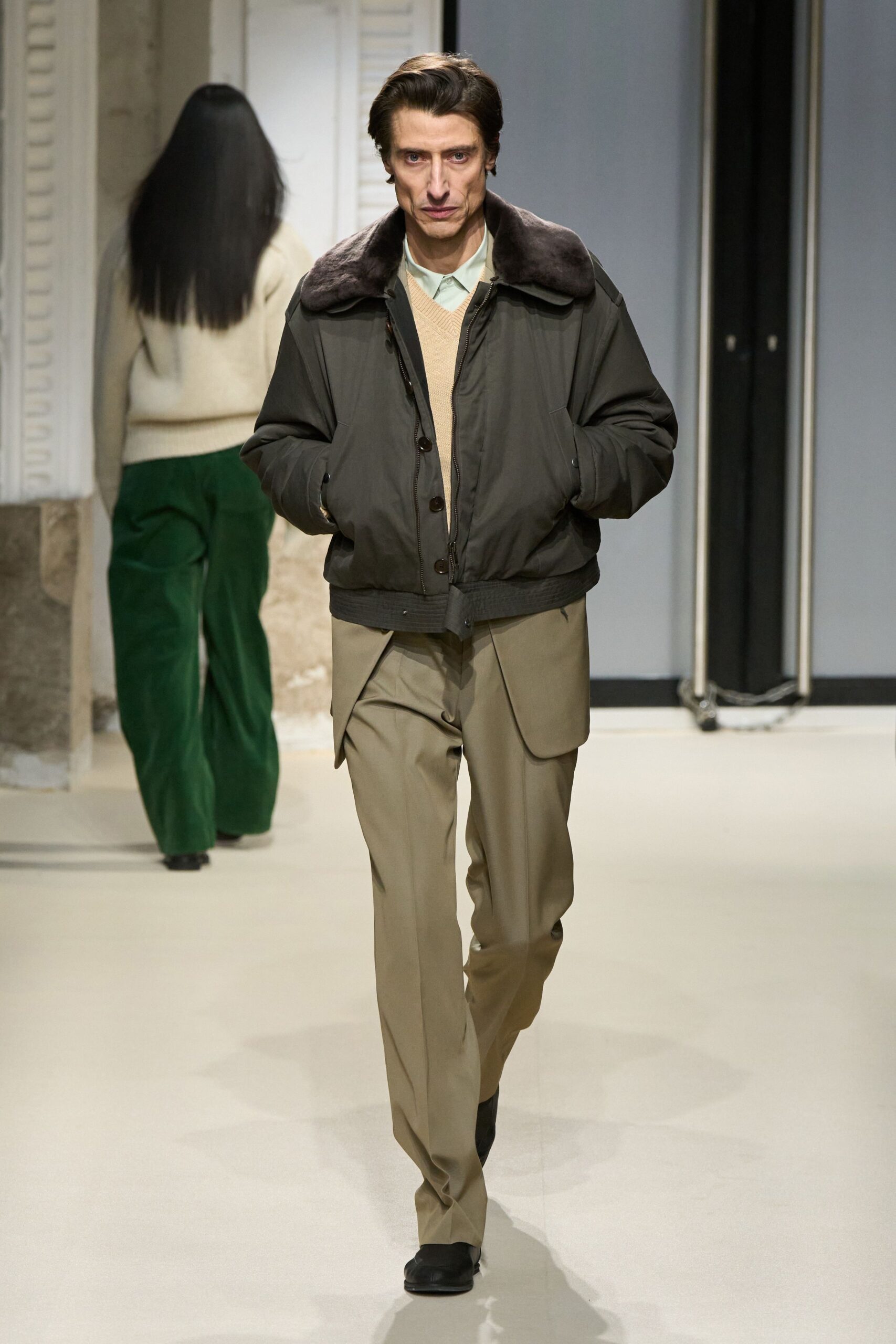 black jacket beige sweater khaki pants