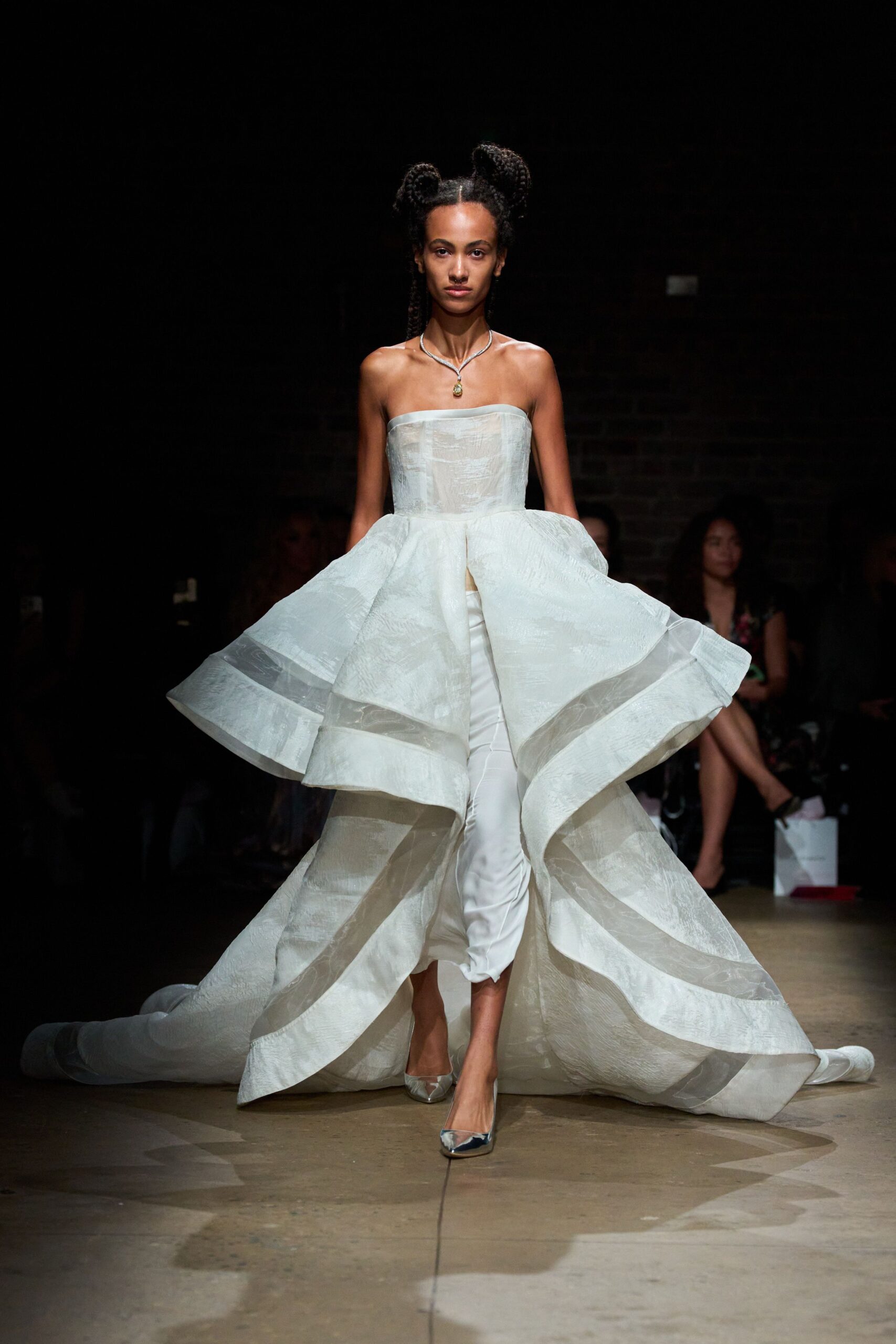 white silk strapless fitted layered pleated flowing gown
