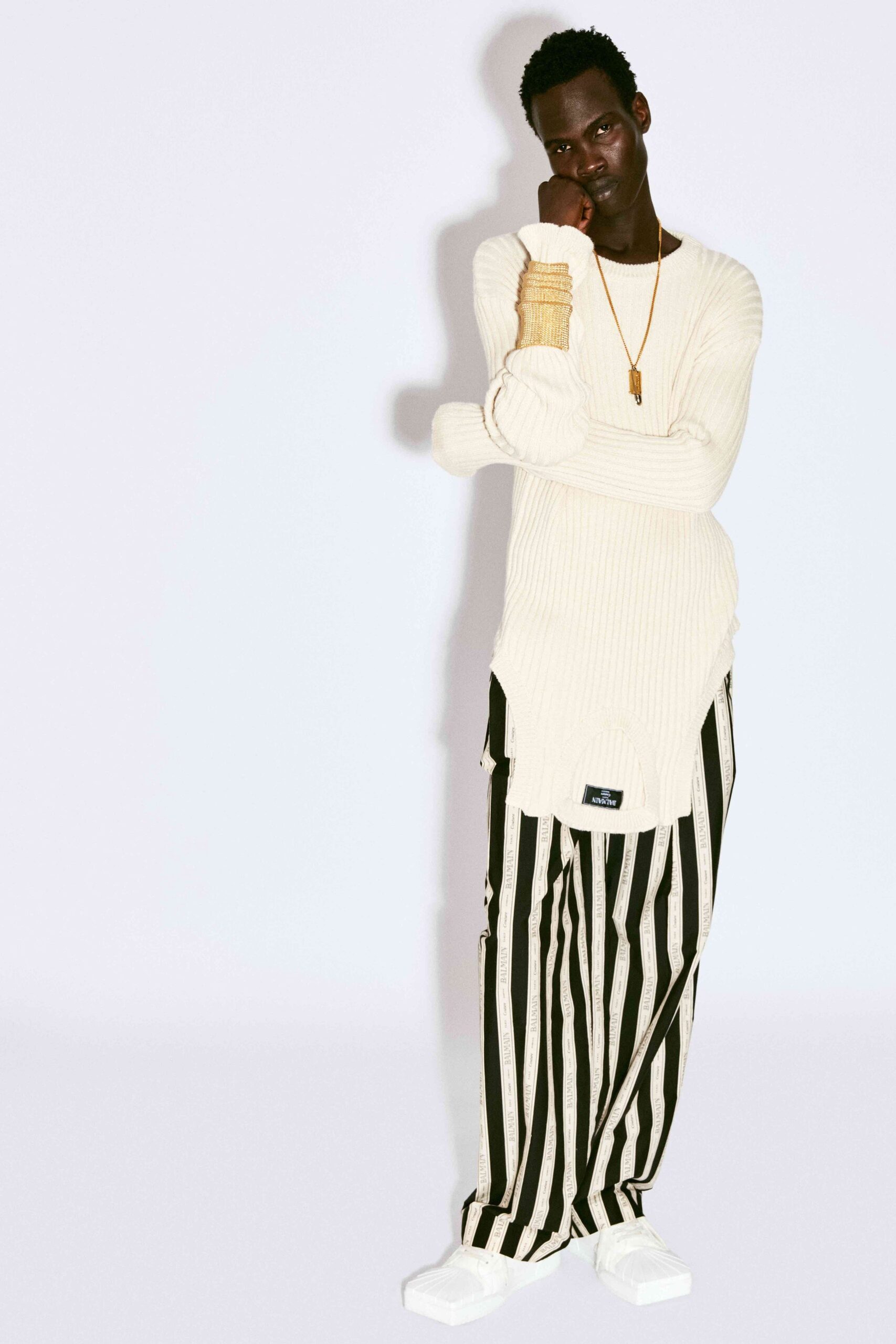white relaxed sweater with striped pants