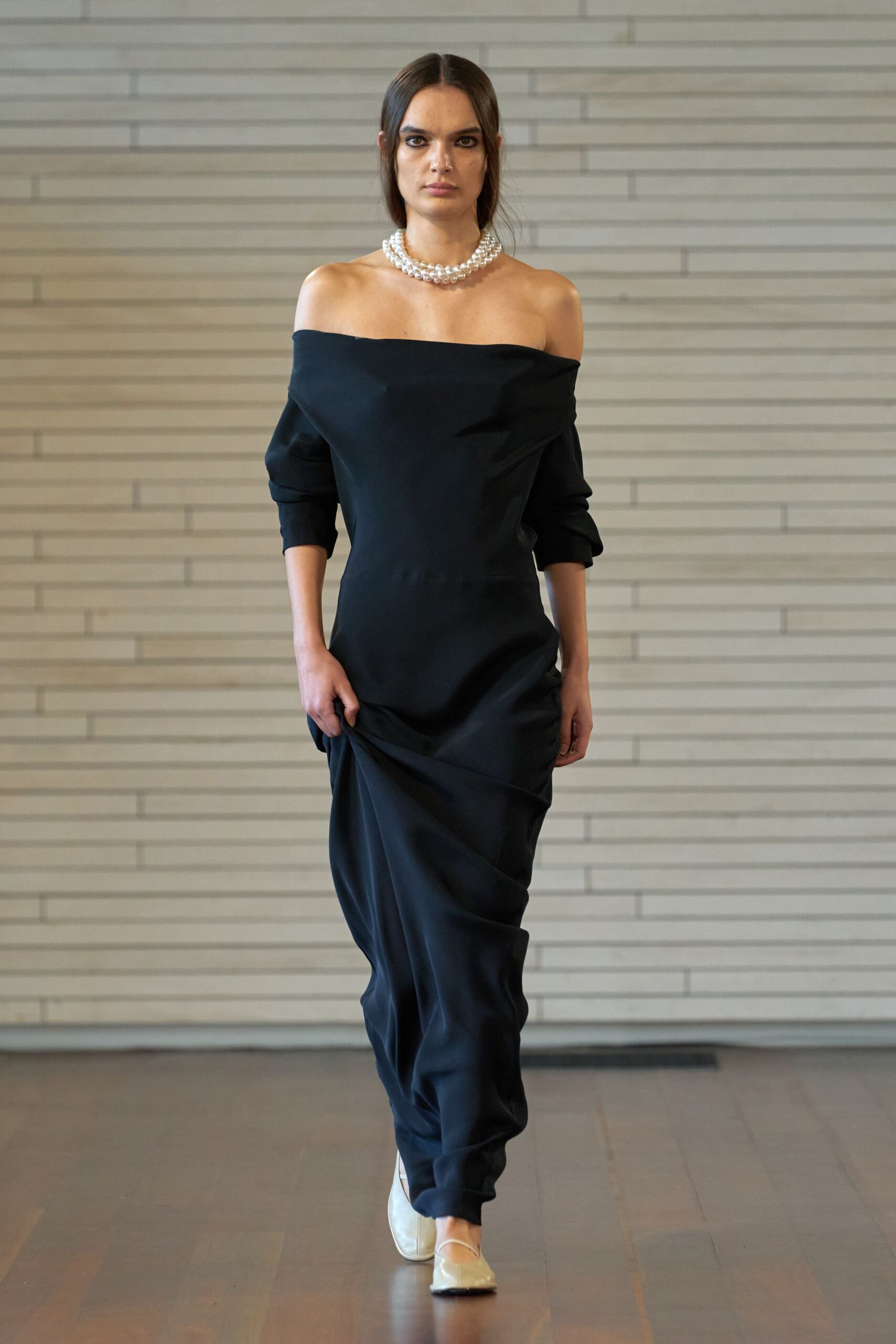 black off-shoulder gown with beige shoes