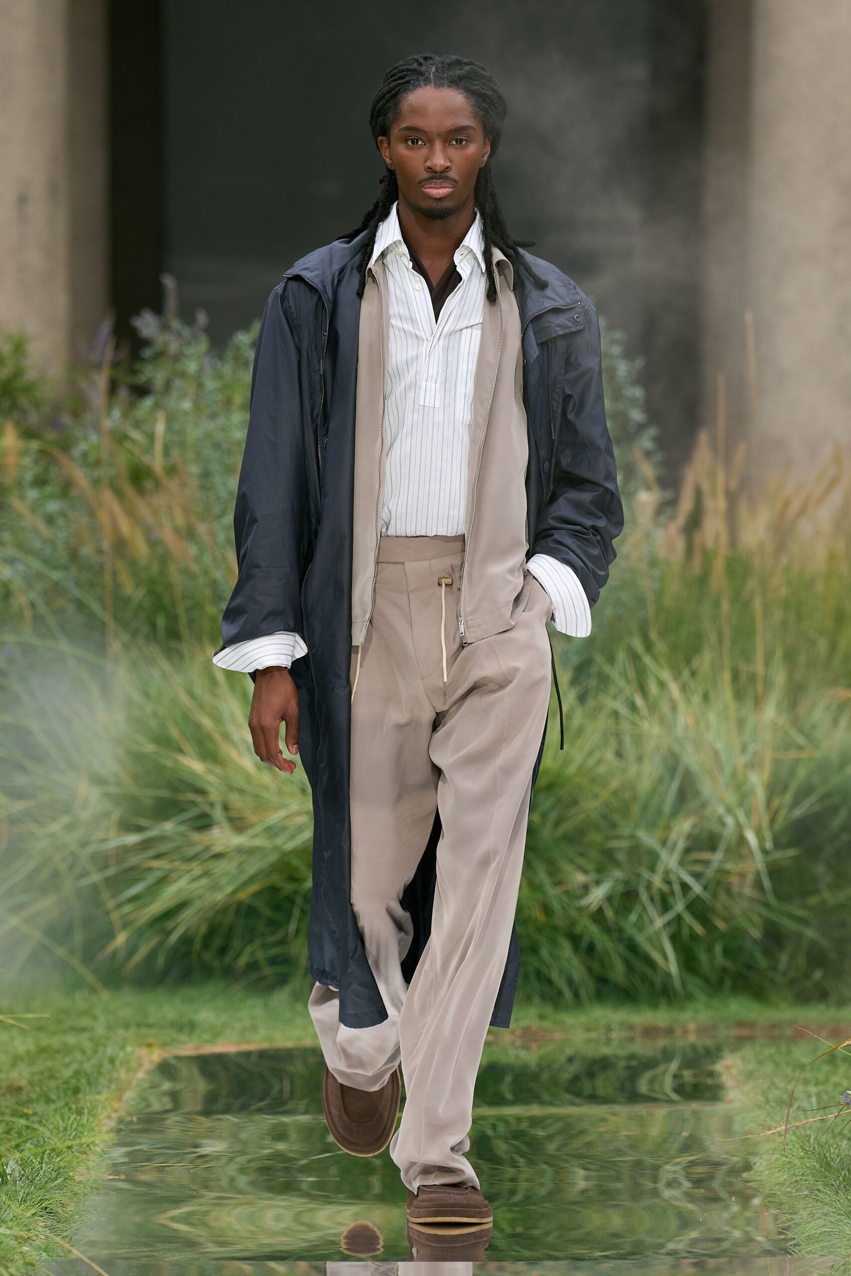 black coat white striped shirt beige pants
