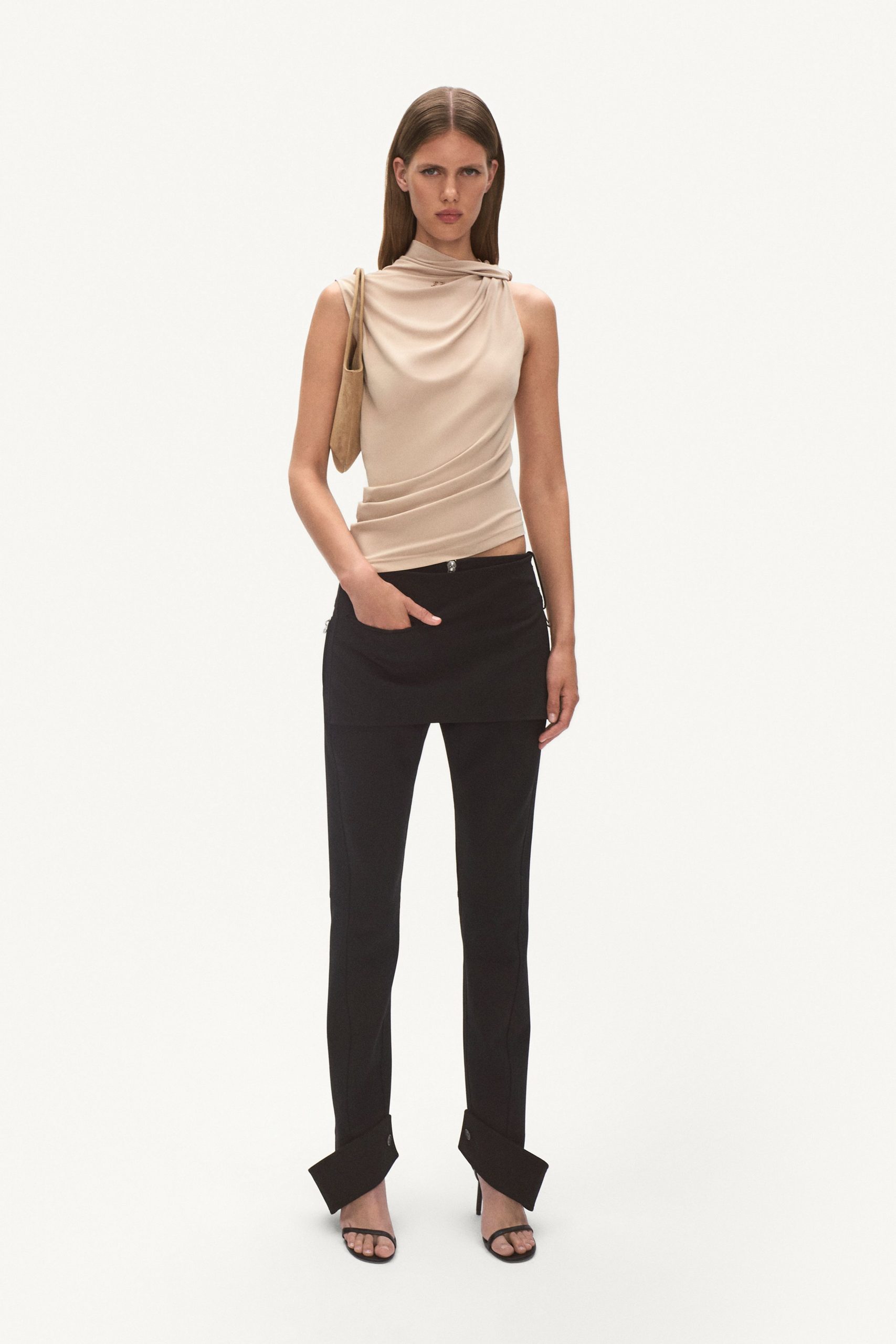 beige silk fitted top with black tailored pants