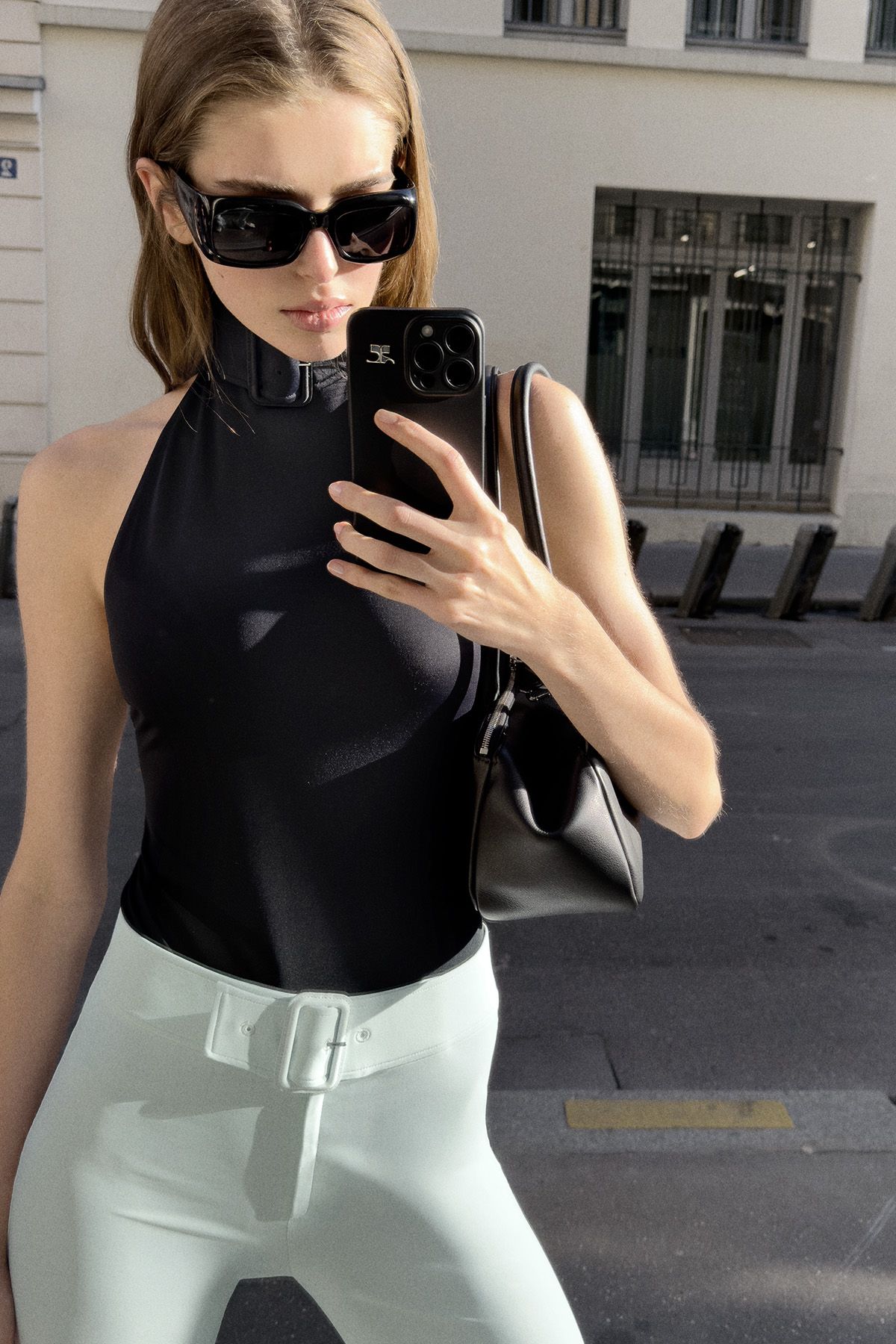 black neoprene bodysuit and mint pants