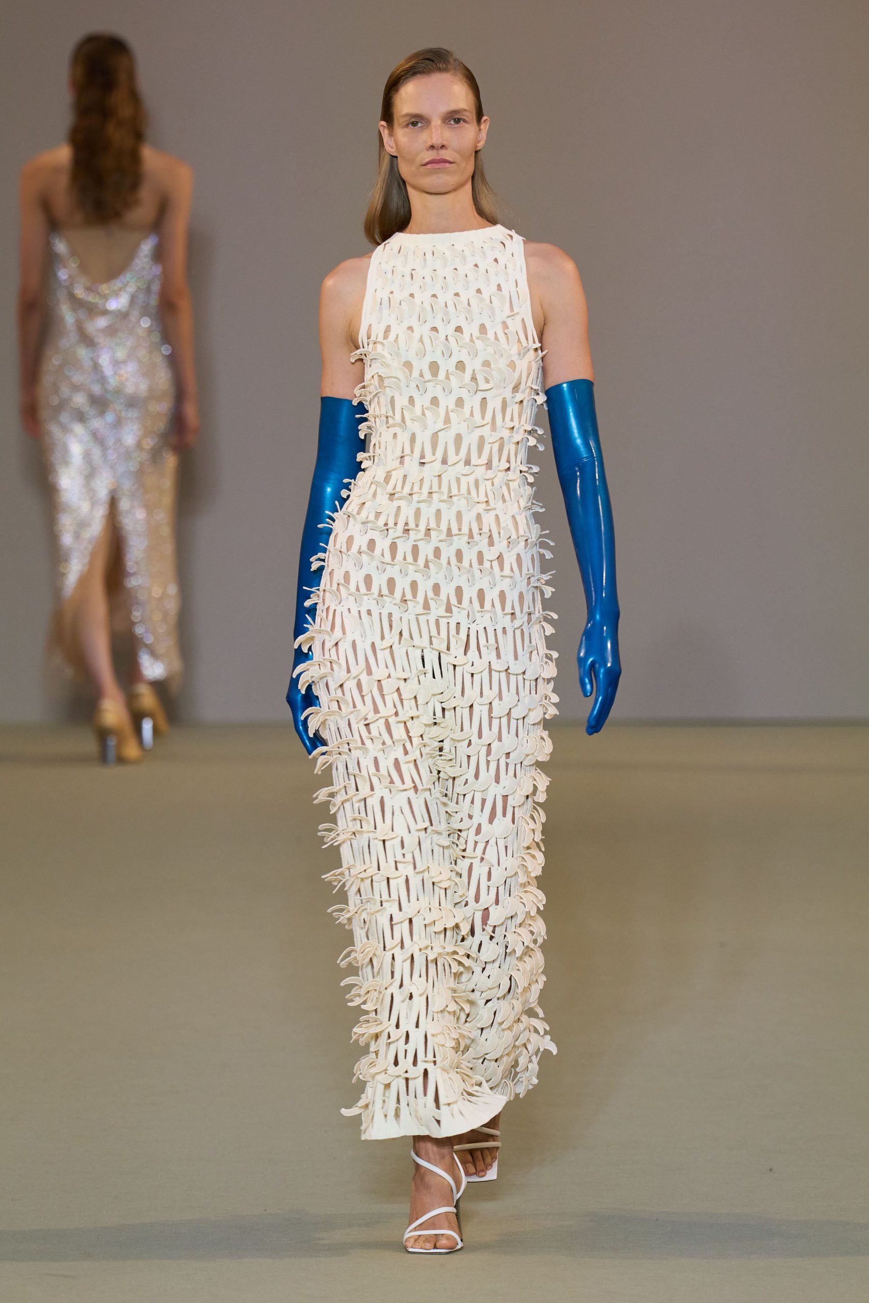 white fitted gown with blue gloves