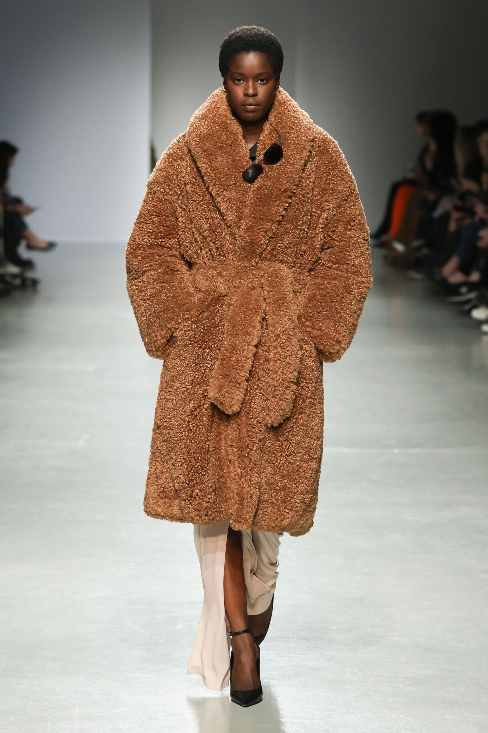 brown faux-fur coat with beige dress