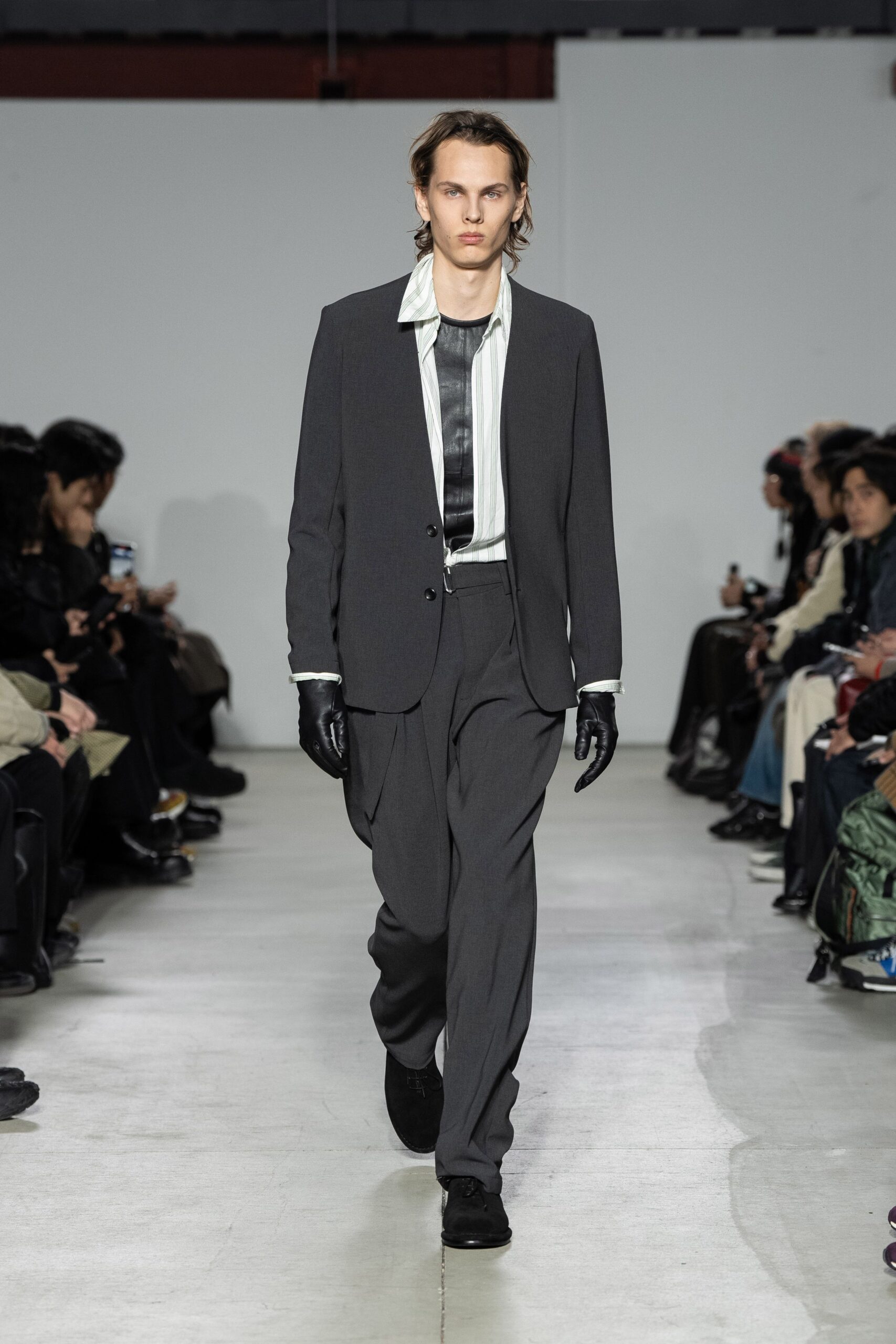 gray tailored suit with black gloves