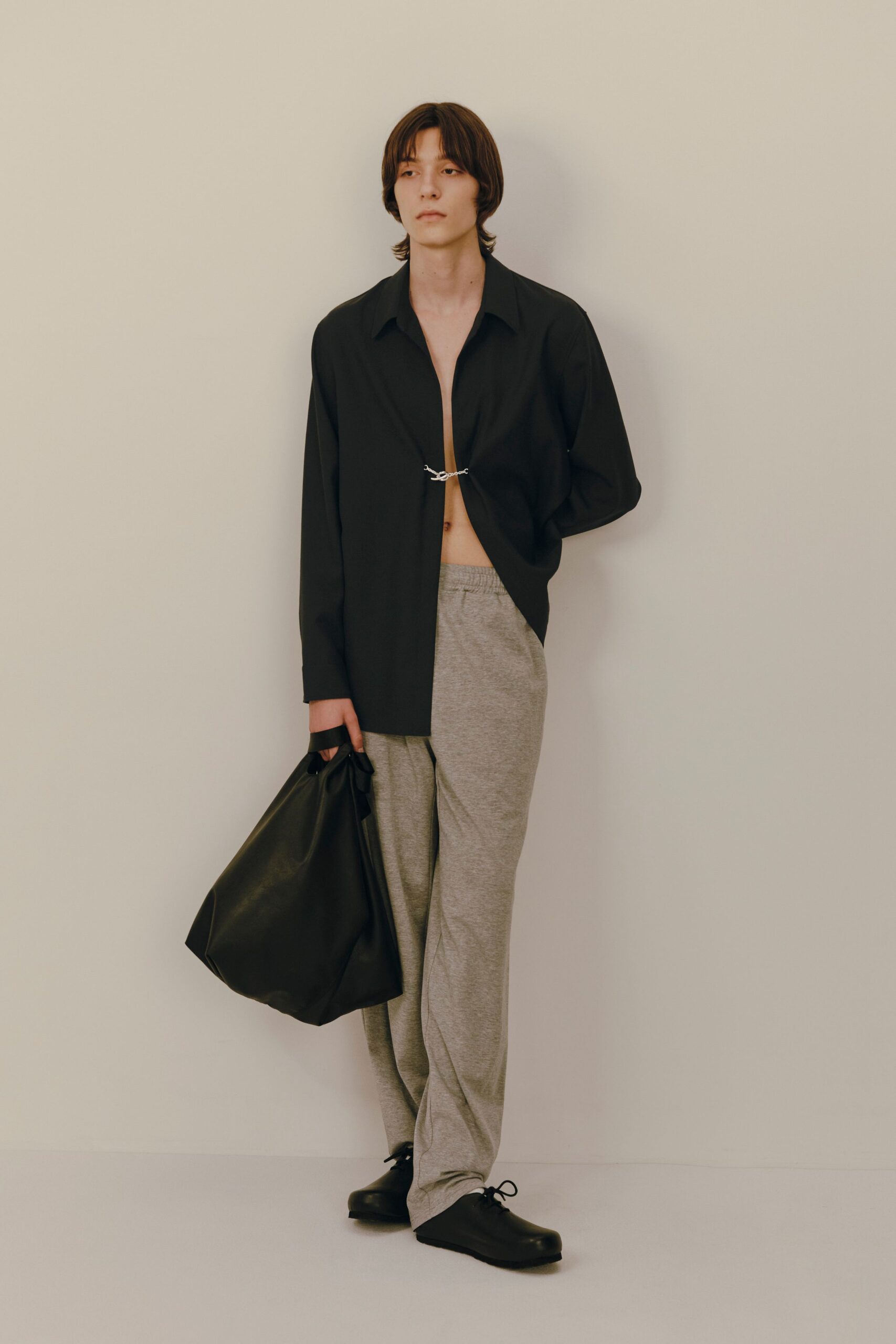 black shirt gray pants black bag