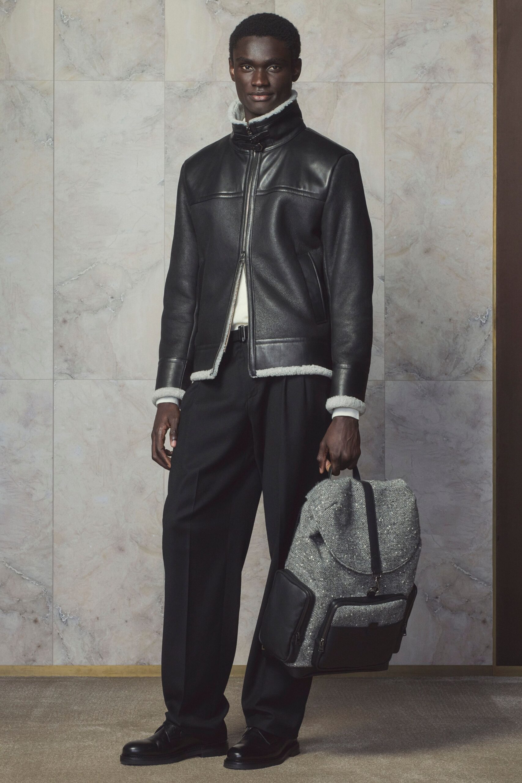 black leather jacket with tailored pants