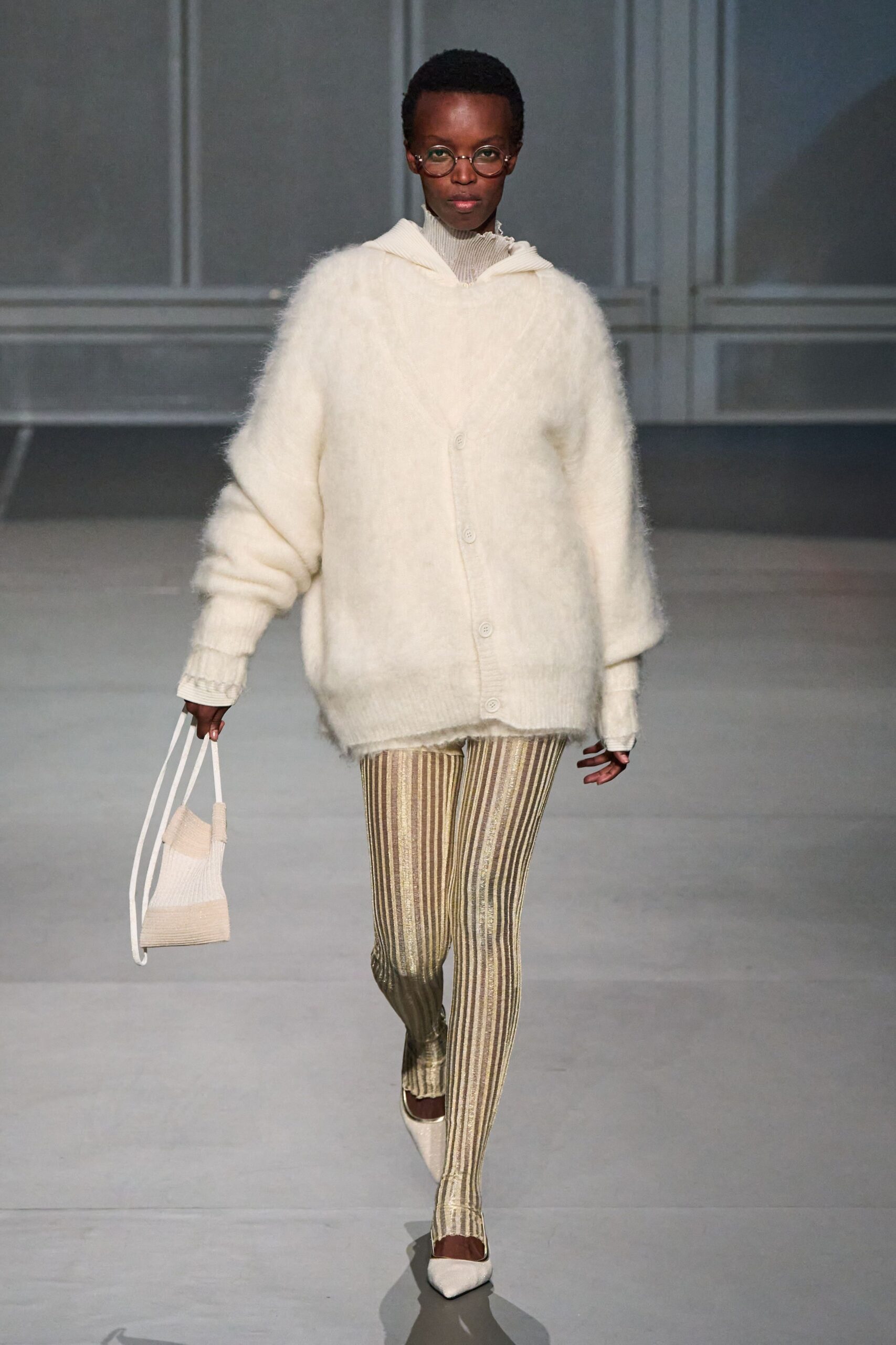 oversized white sweater with gold striped pants