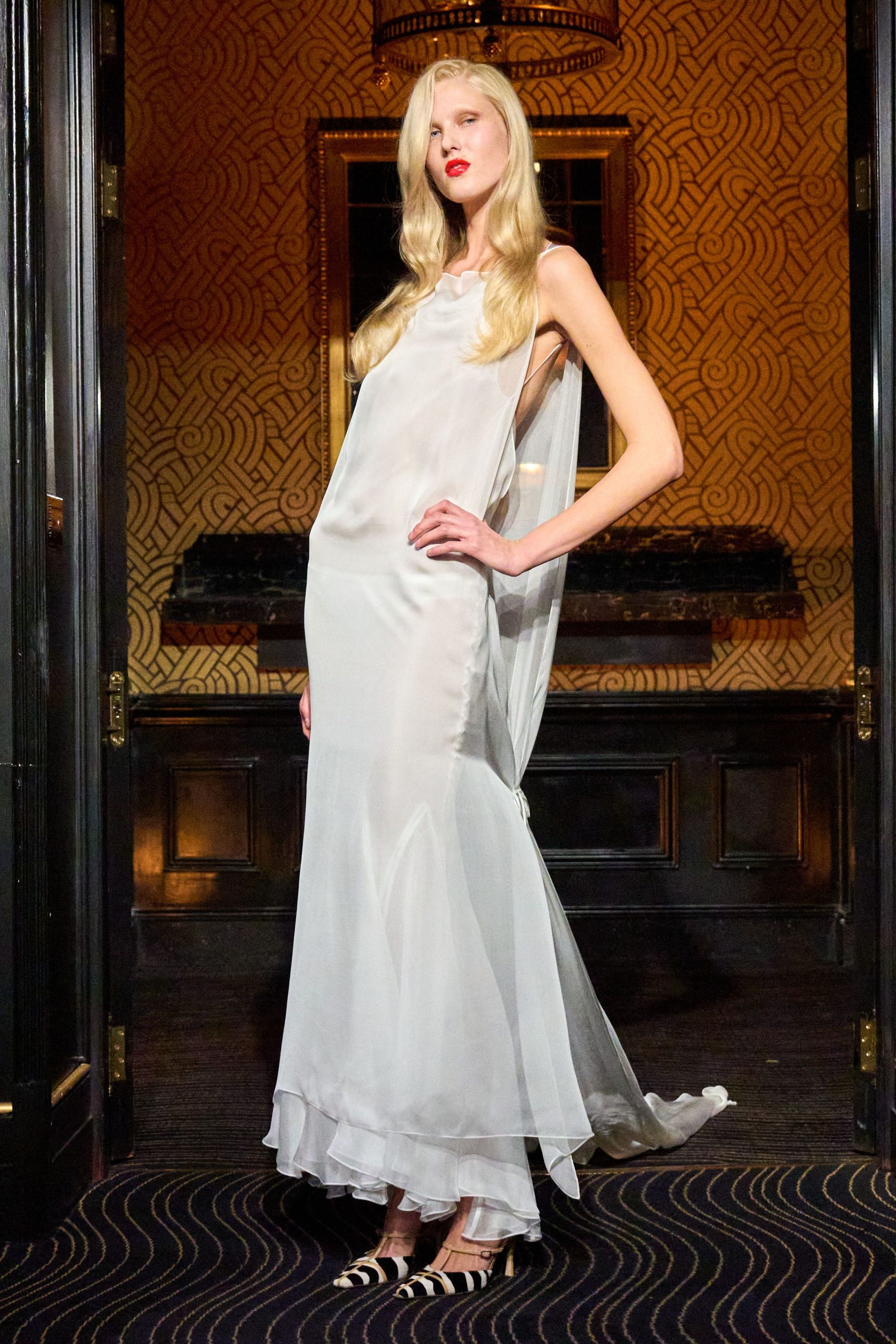 white silk draped gown with striped shoes