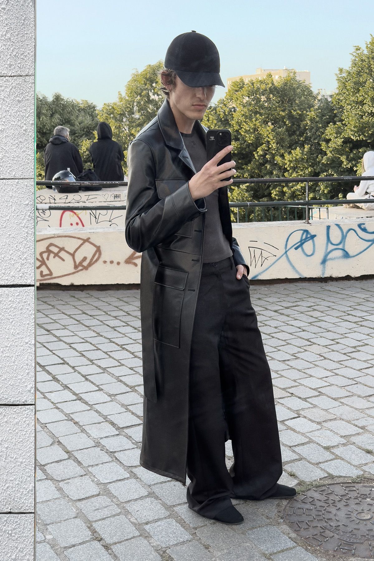 black leather coat with relaxed pants