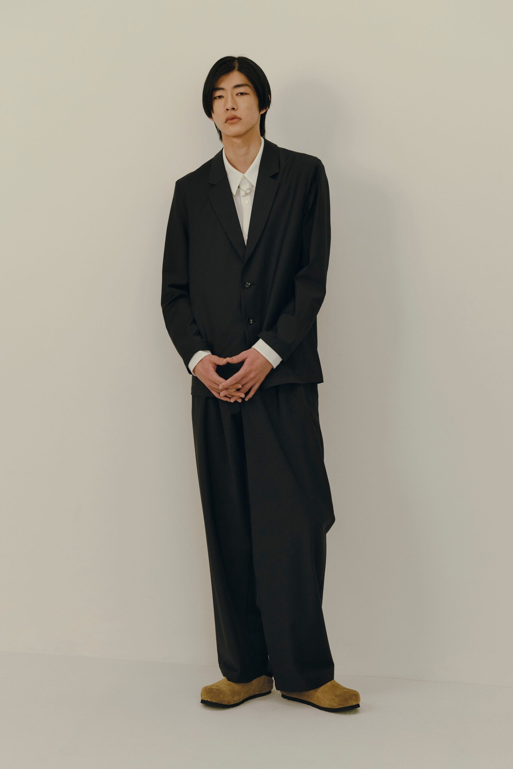 black relaxed suit with brown shoes