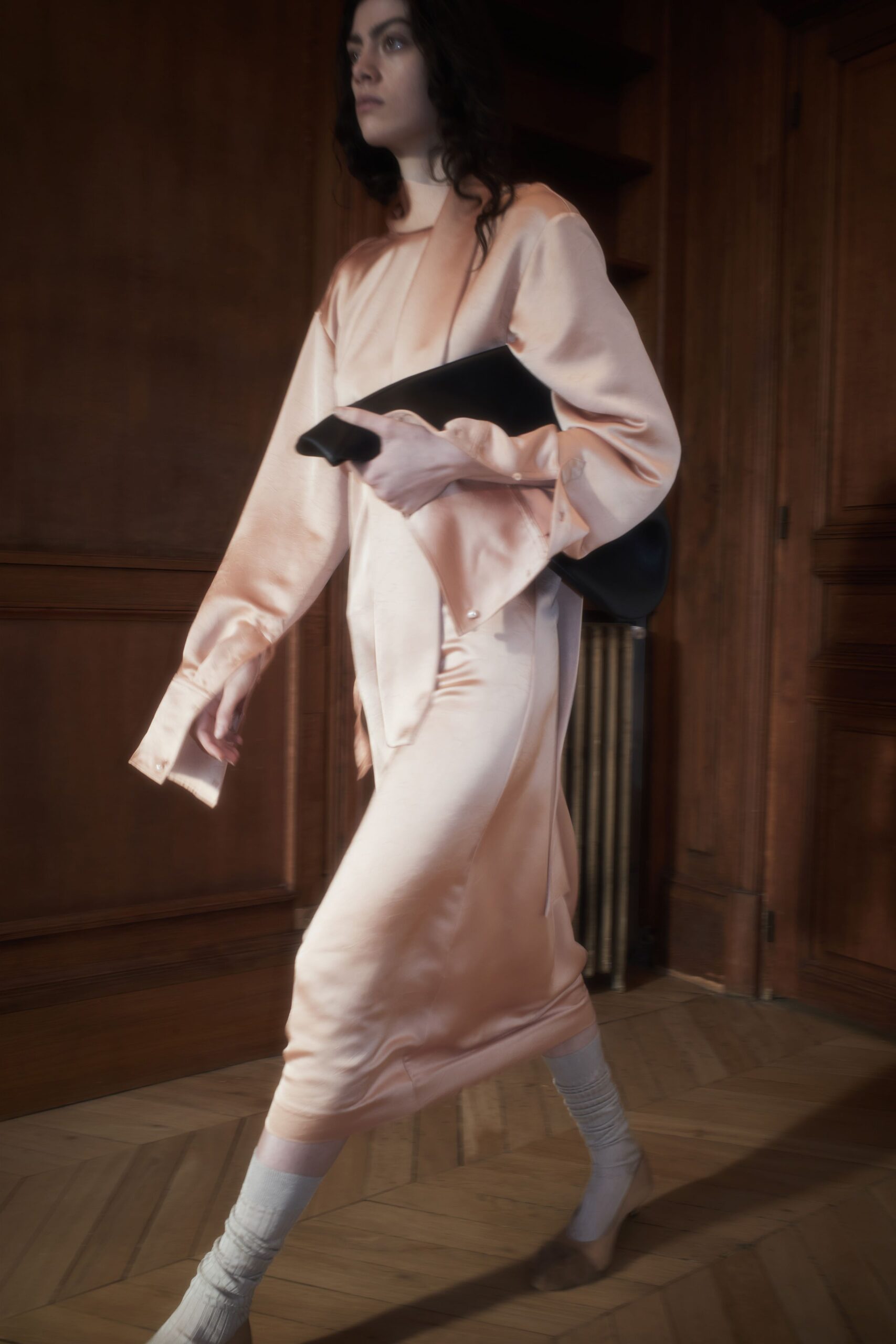 pink silk midi dress with black bag