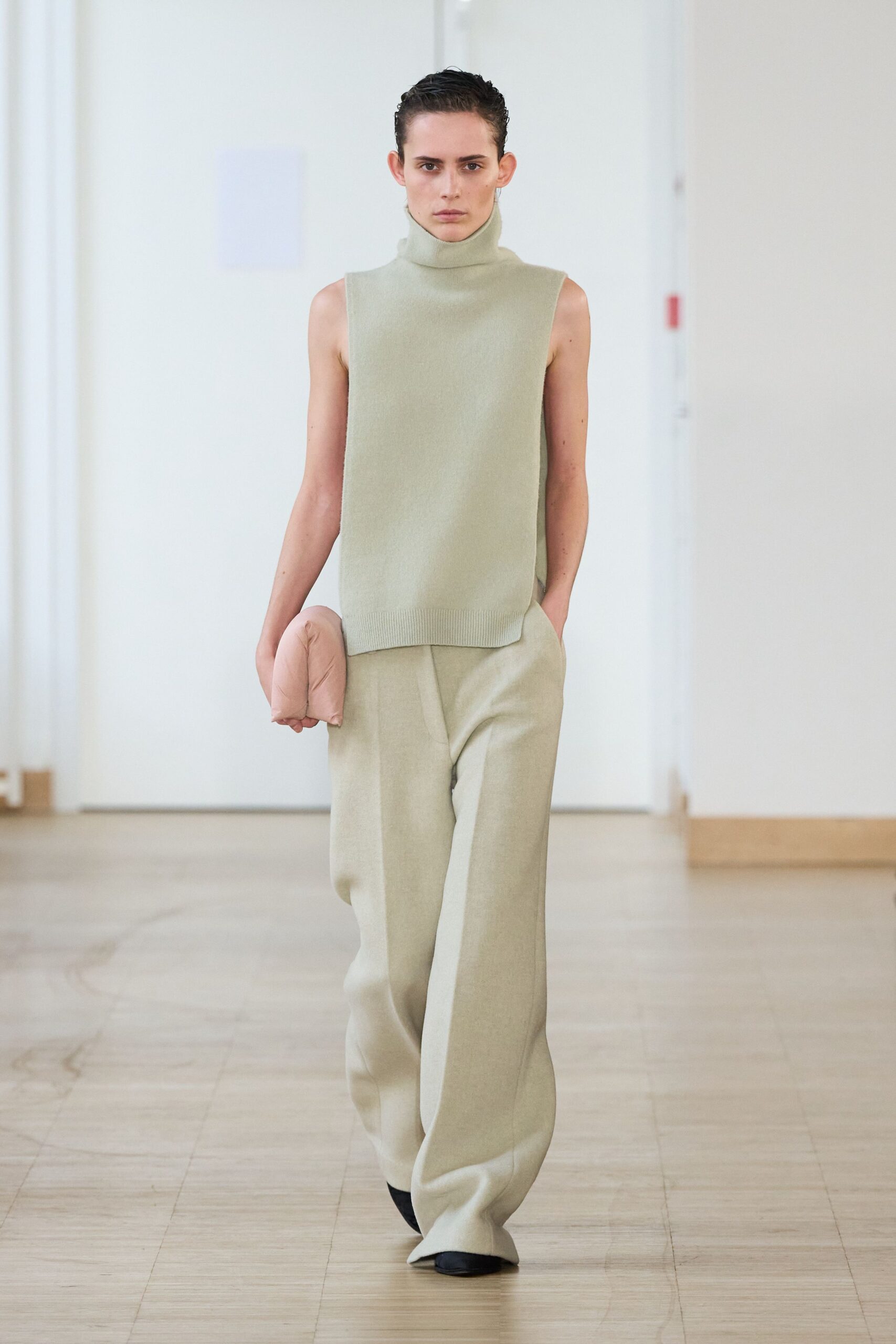 green wool sleeveless top with beige pants