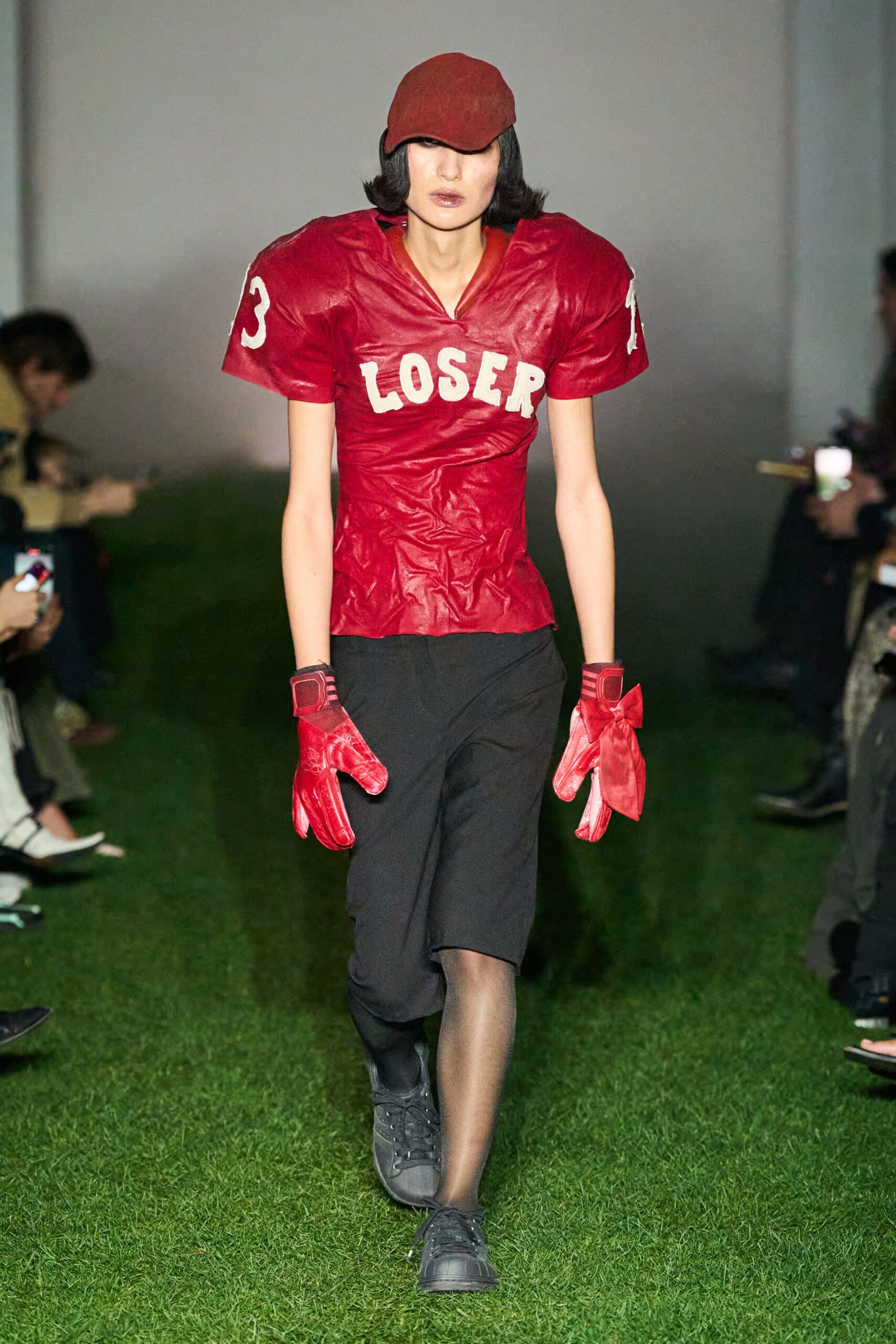 red fitted top with black pants