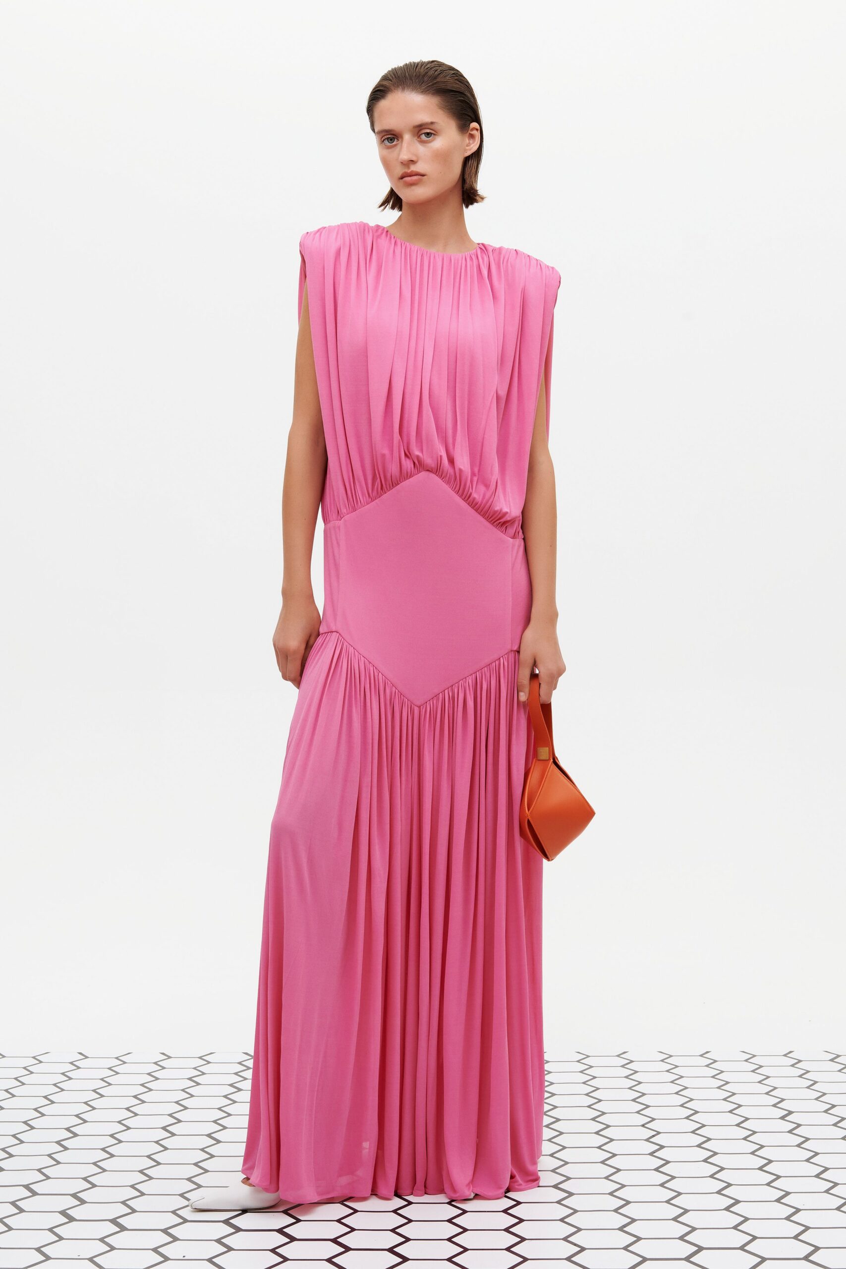 pink silk pleated gown with orange bag