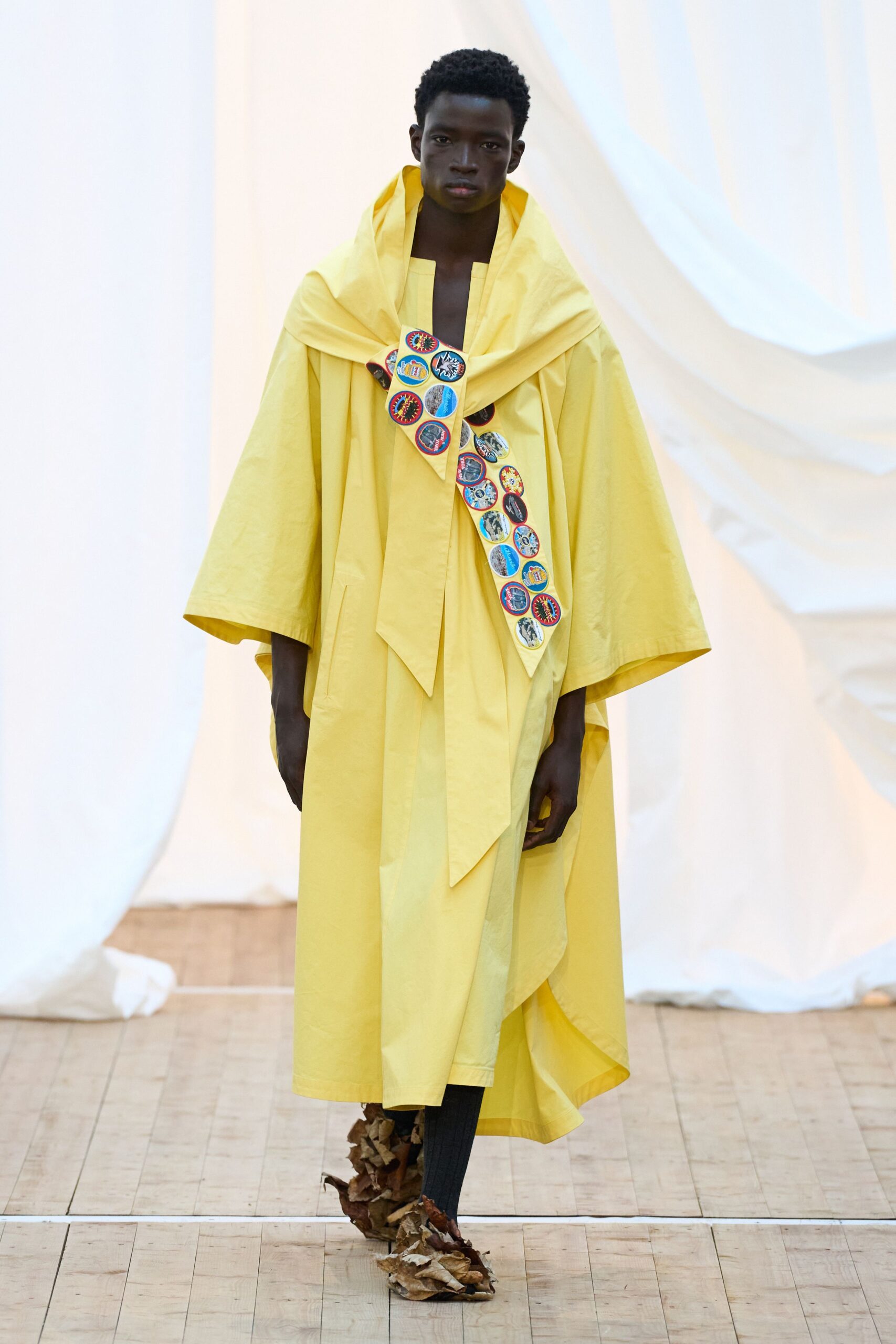 yellow cape with black pants