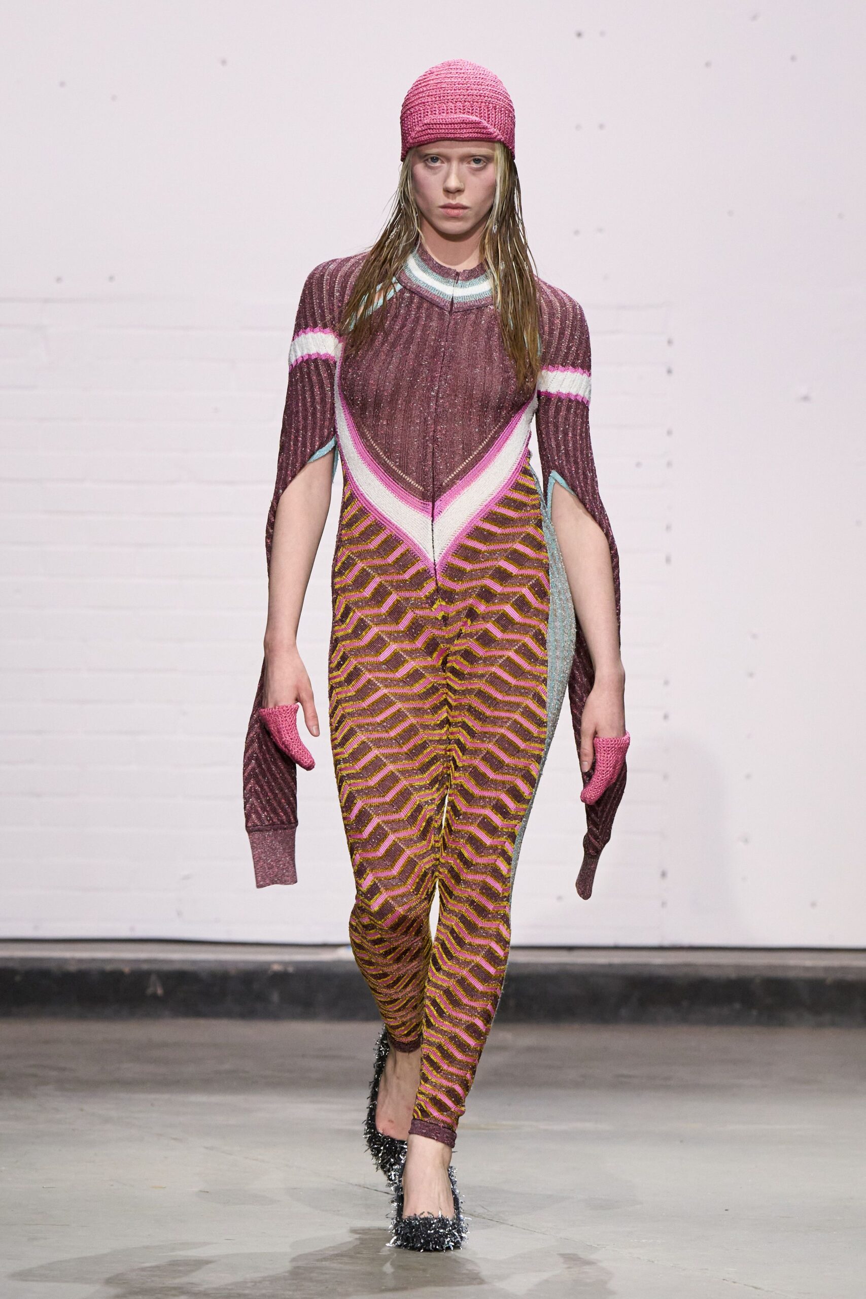 red and pink knit catsuit with cape