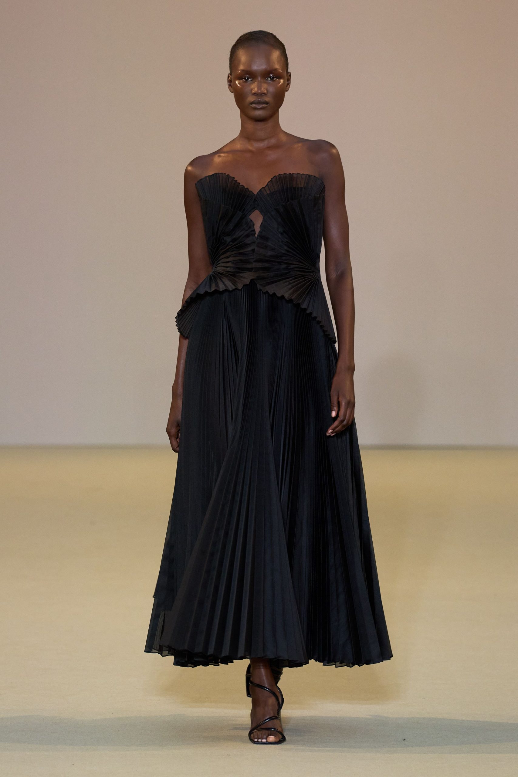 black pleated gown with strappy shoes