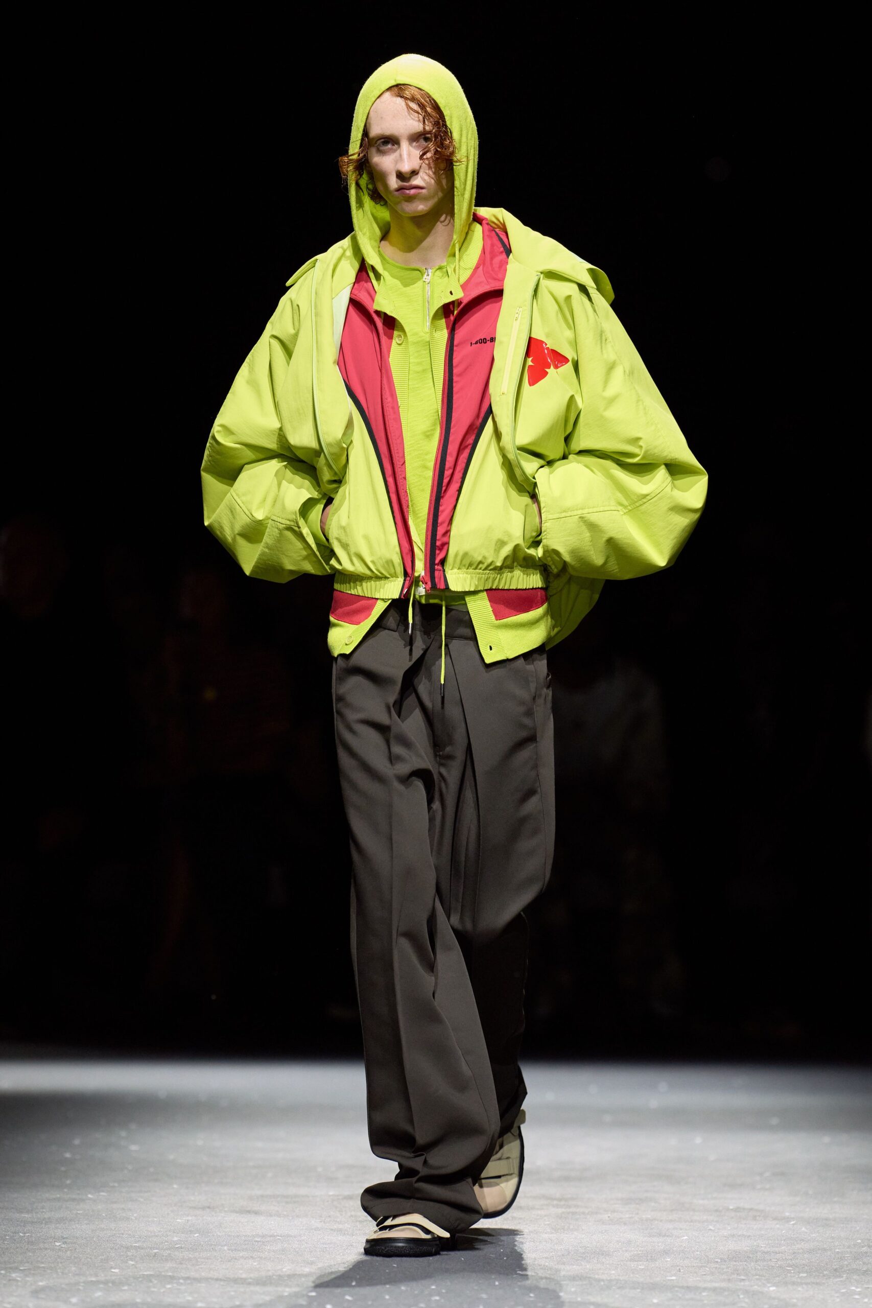 green hooded jacket with black pants