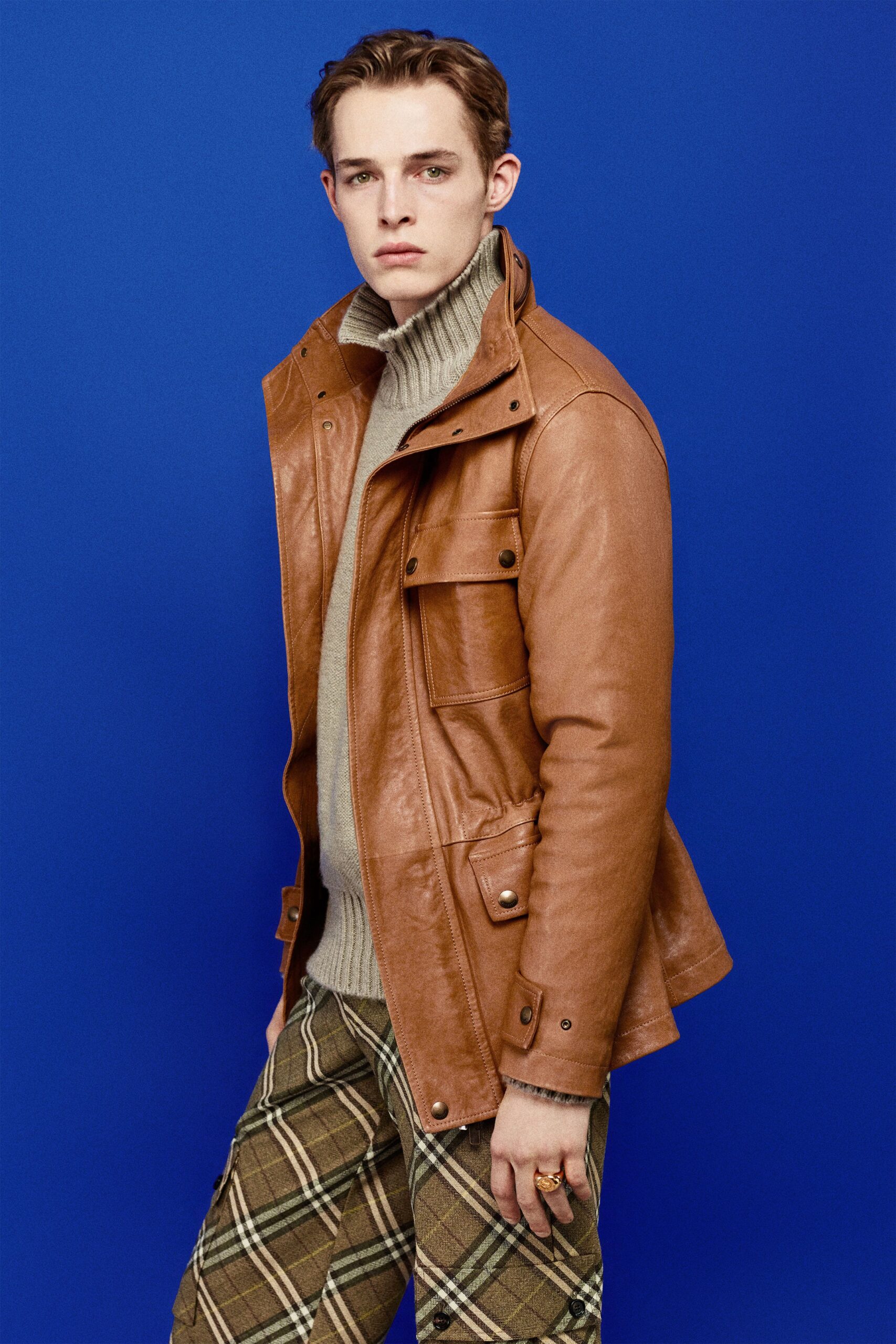 brown leather jacket beige sweater plaid pants