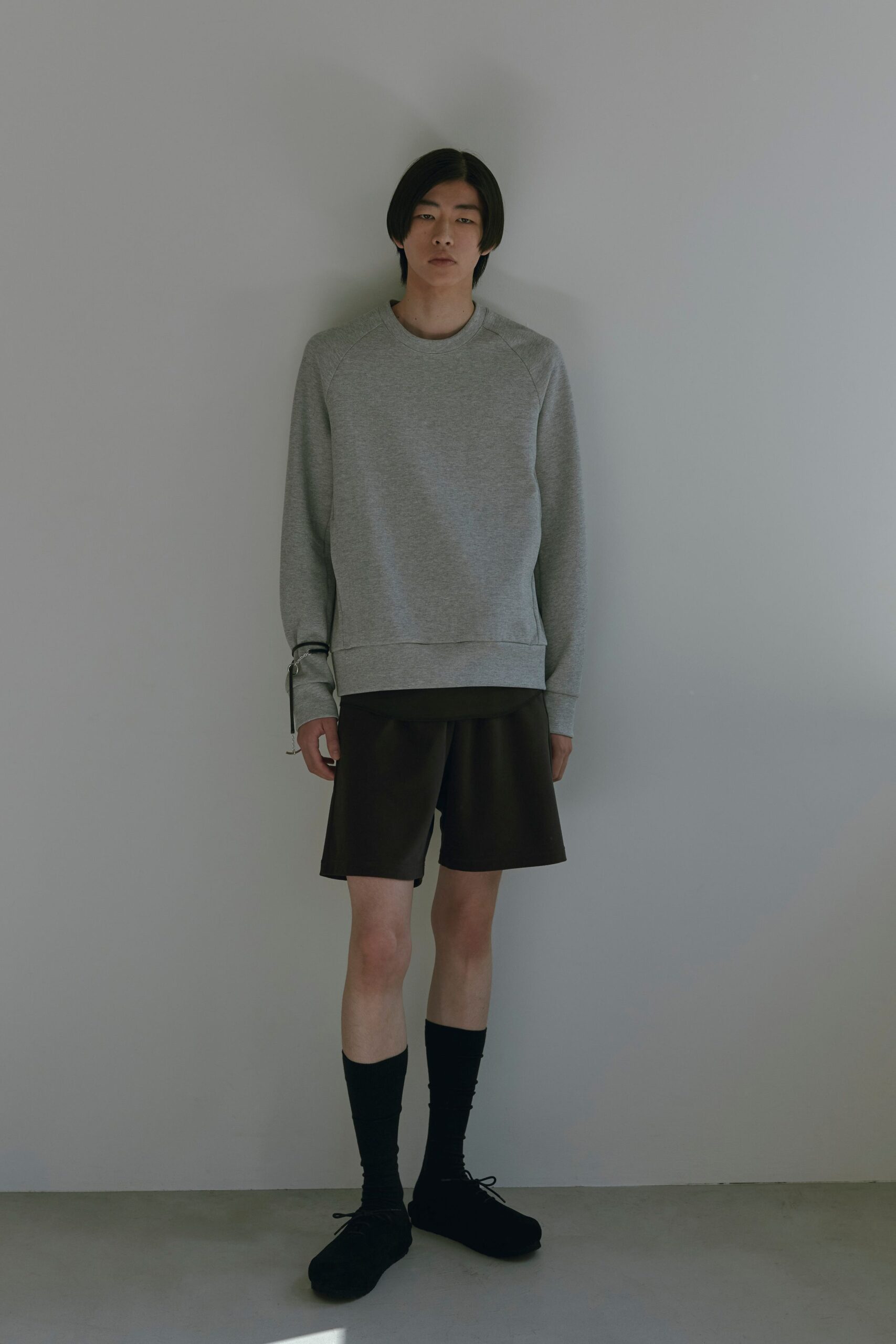 gray relaxed sweater with brown shorts