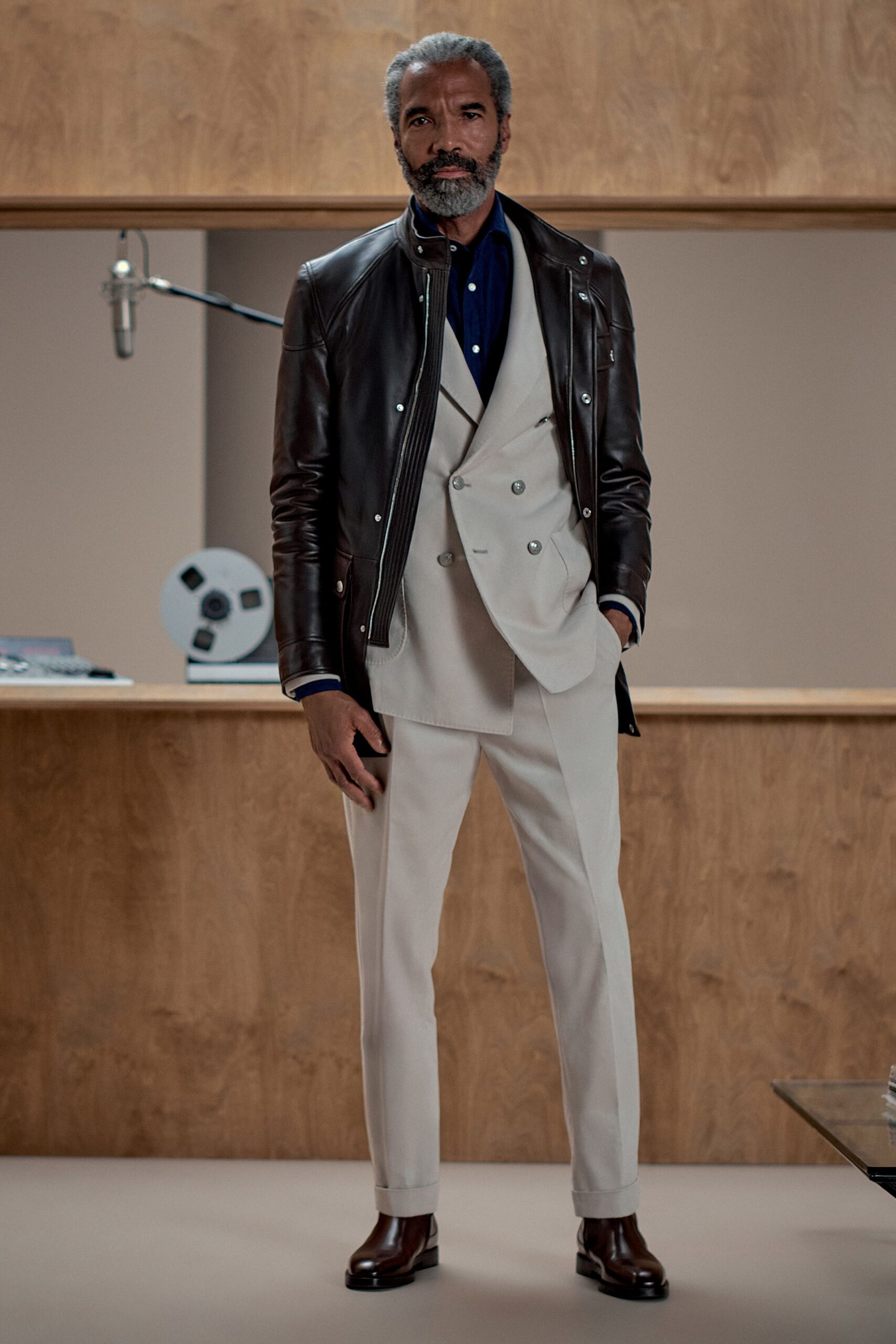 brown leather jacket and beige suit