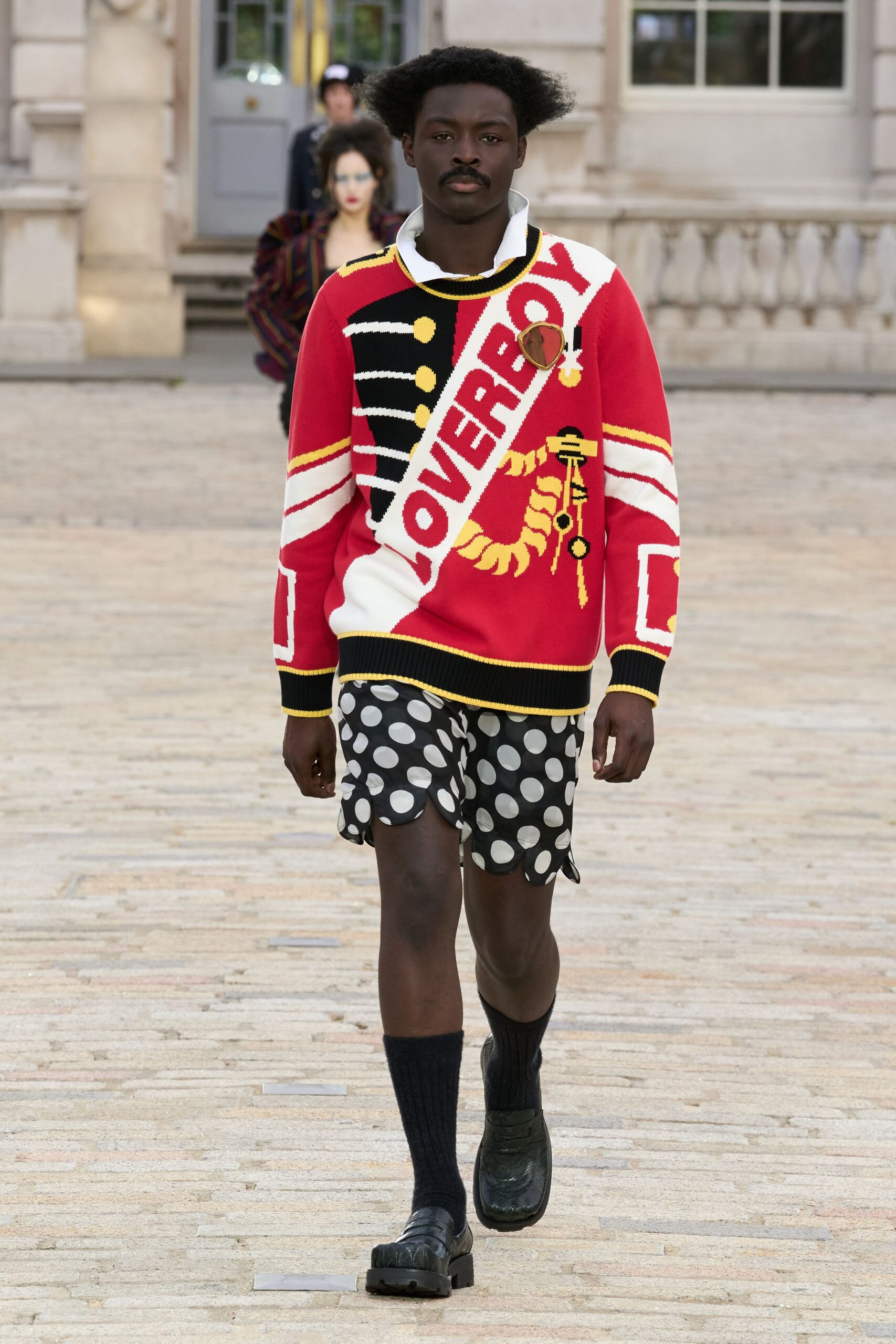 red embroidered sweater and polka-dot shorts