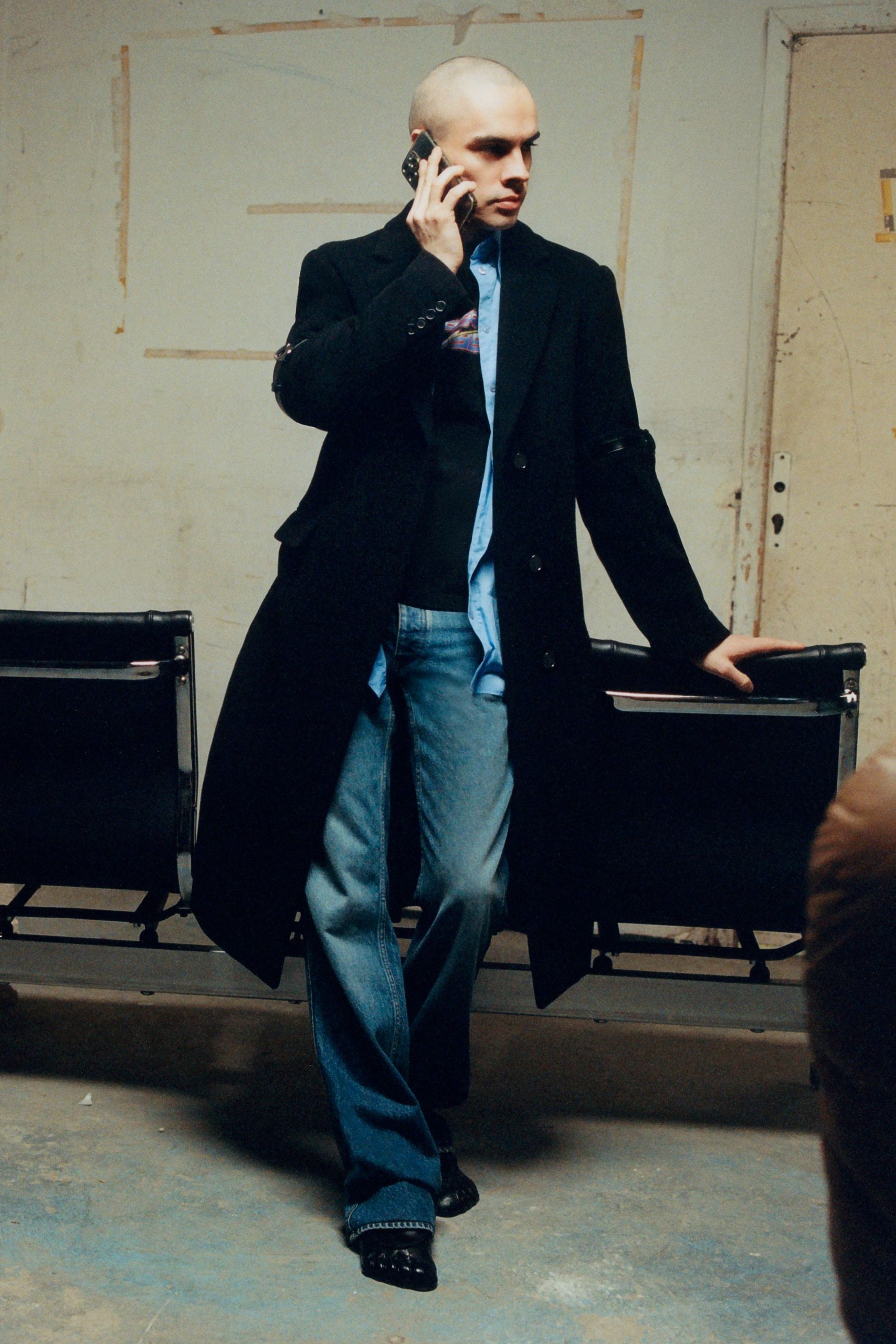 black coat blue shirt denim pants