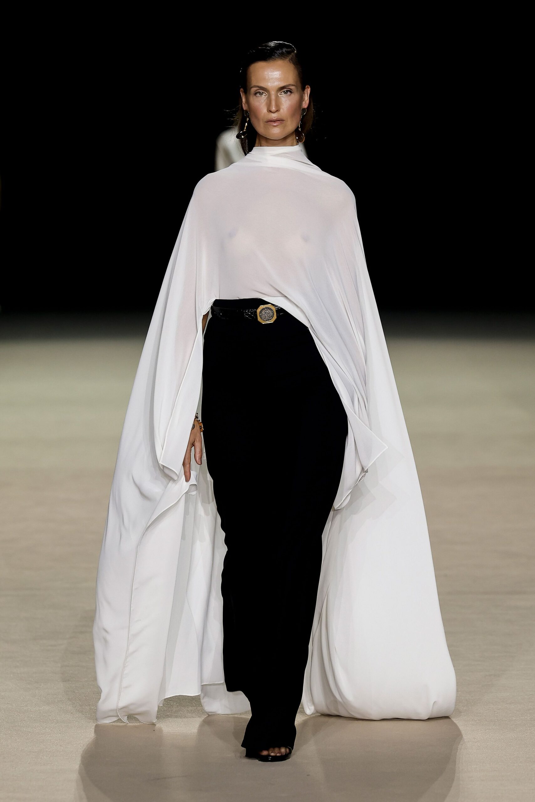 white silk sleeveless high-neck relaxed draped flowing cape