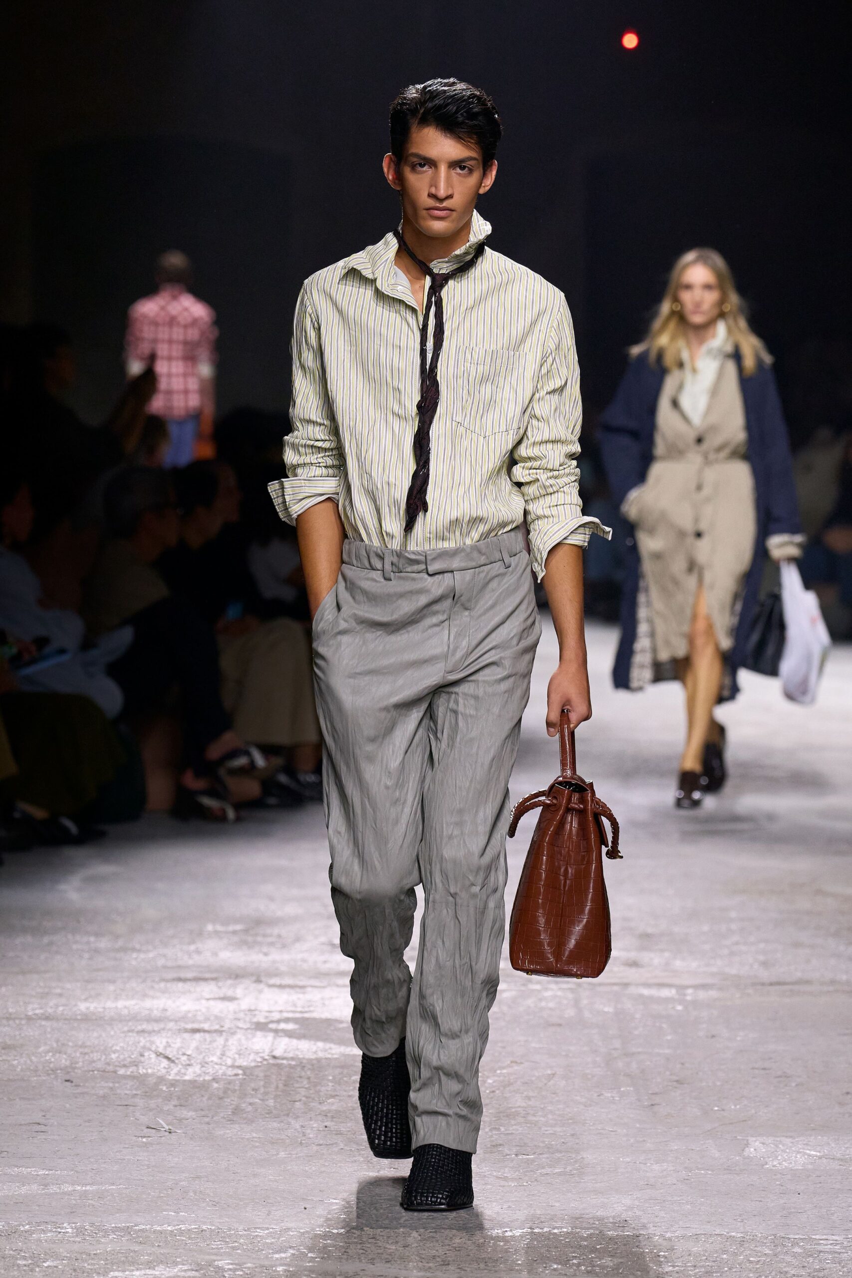 striped shirt gray pants brown bag