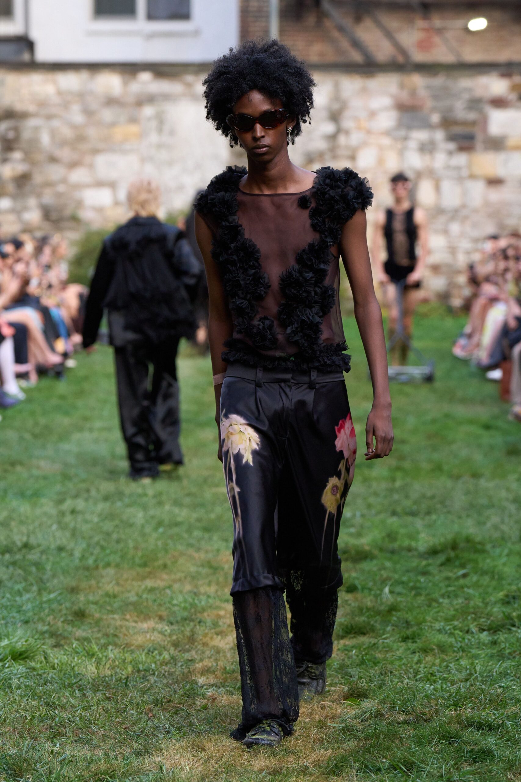 black ruffled top with flared pants