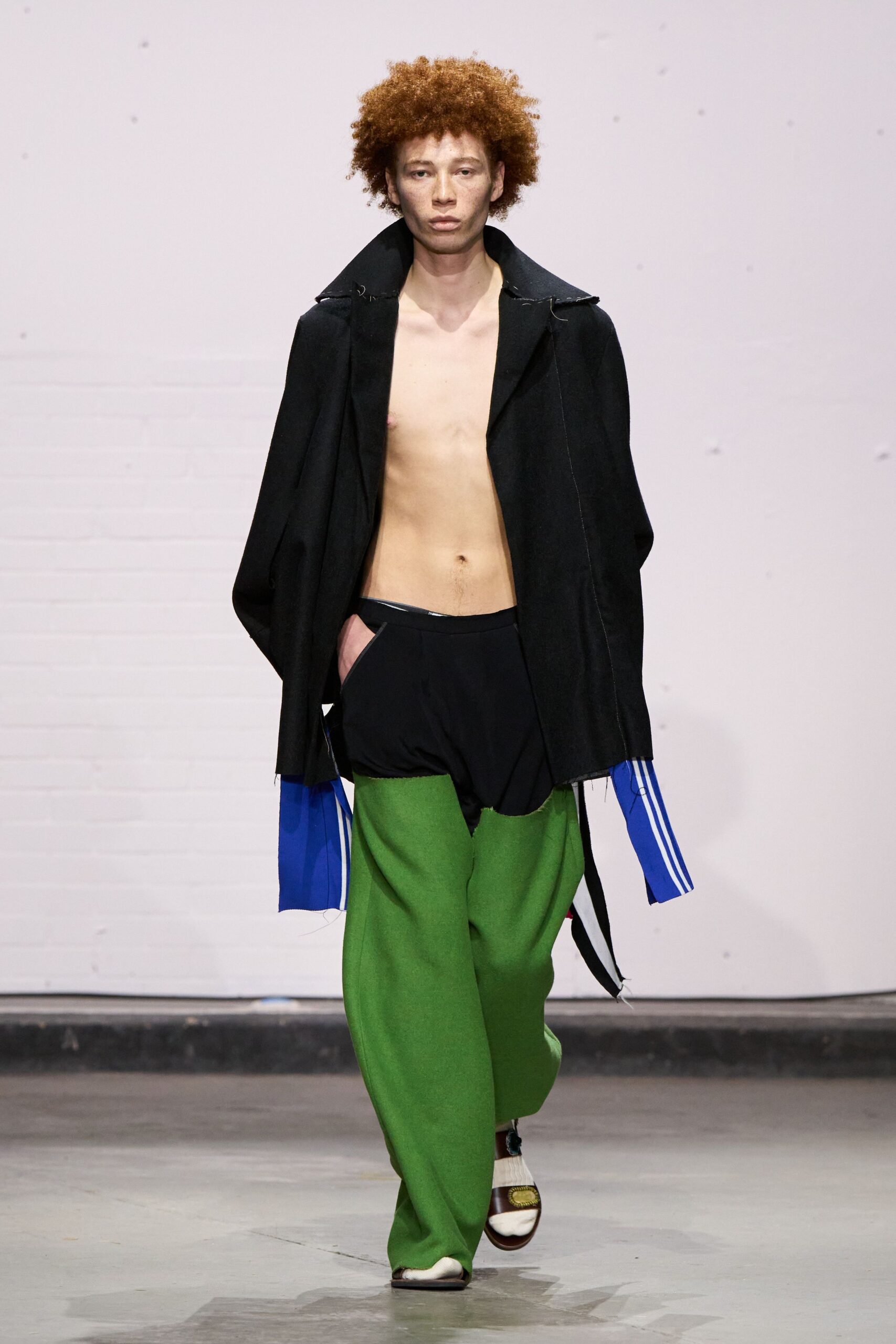 black coat green pants outfit