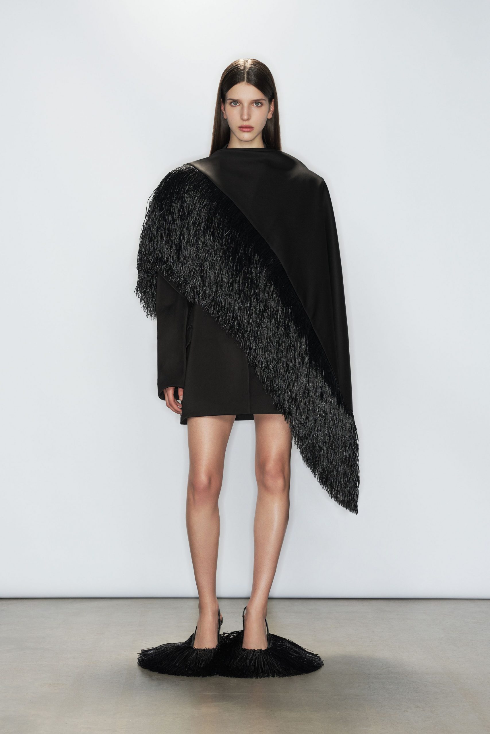 black fringed cape and mini-dress