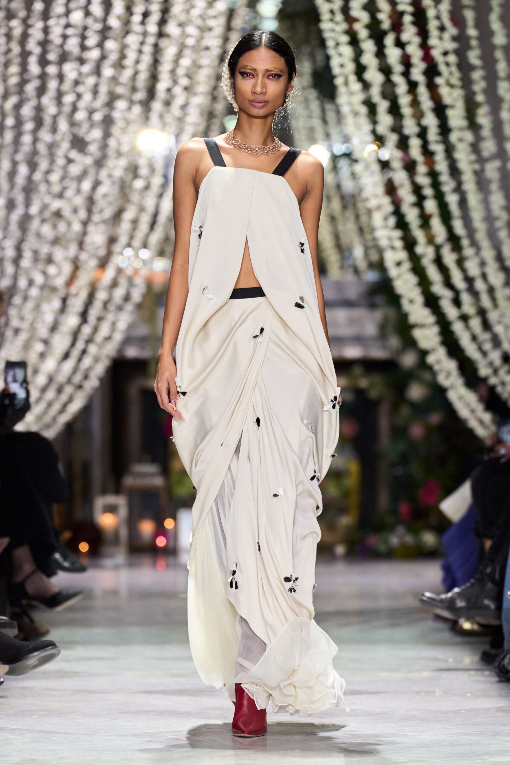 white silk draped gown with red boots