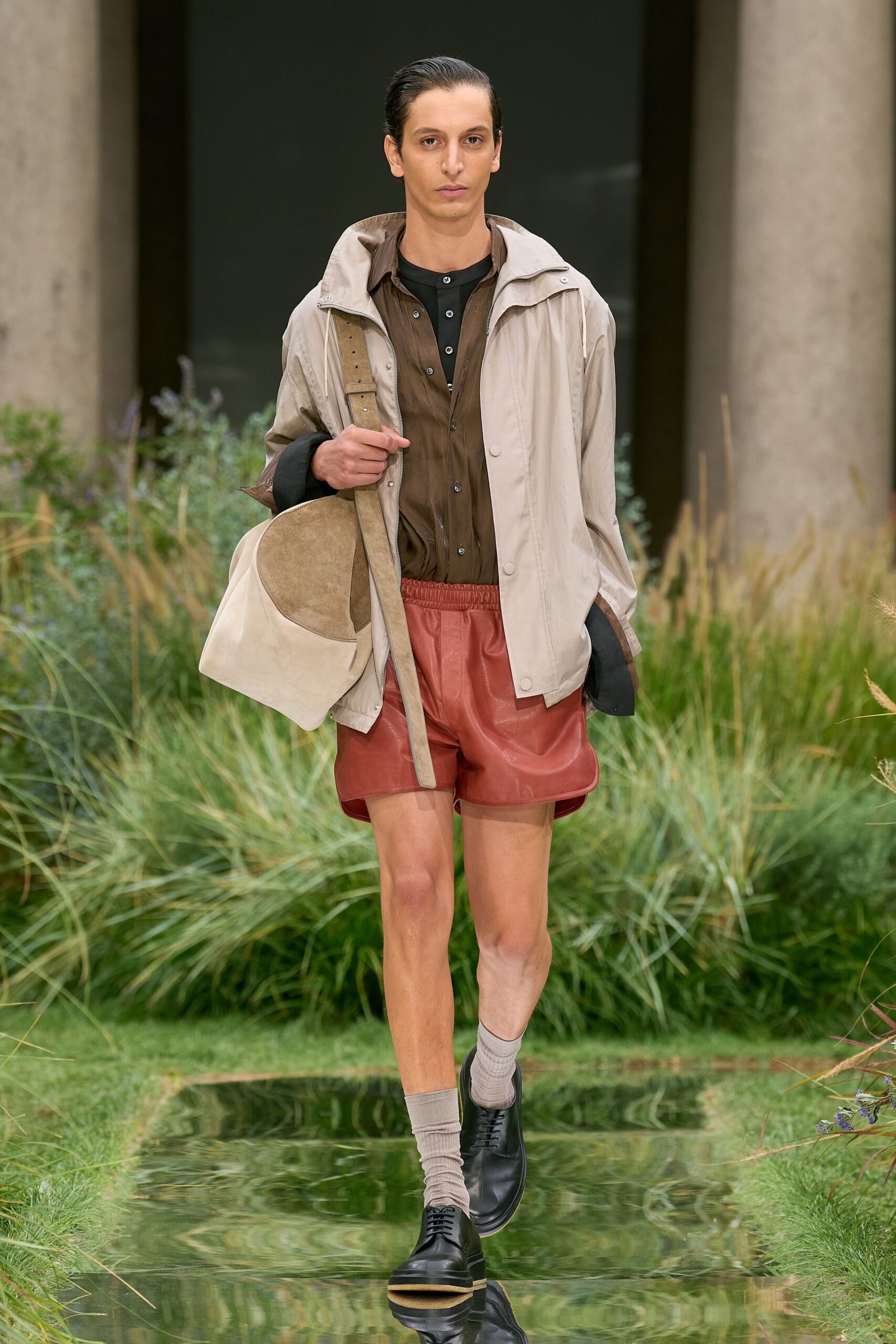 beige jacket brown shirt red shorts