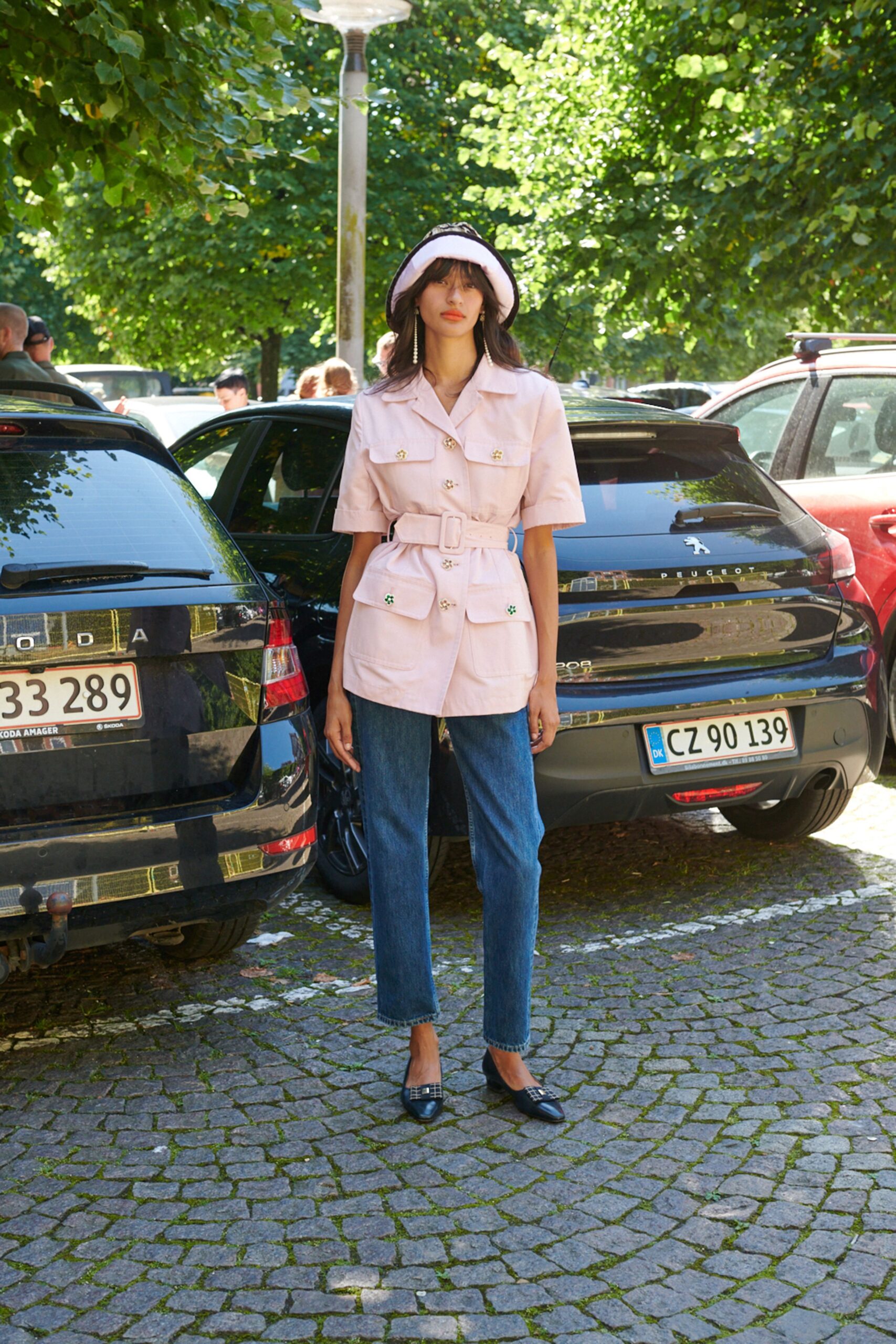 pink belted jacket with denim pants
