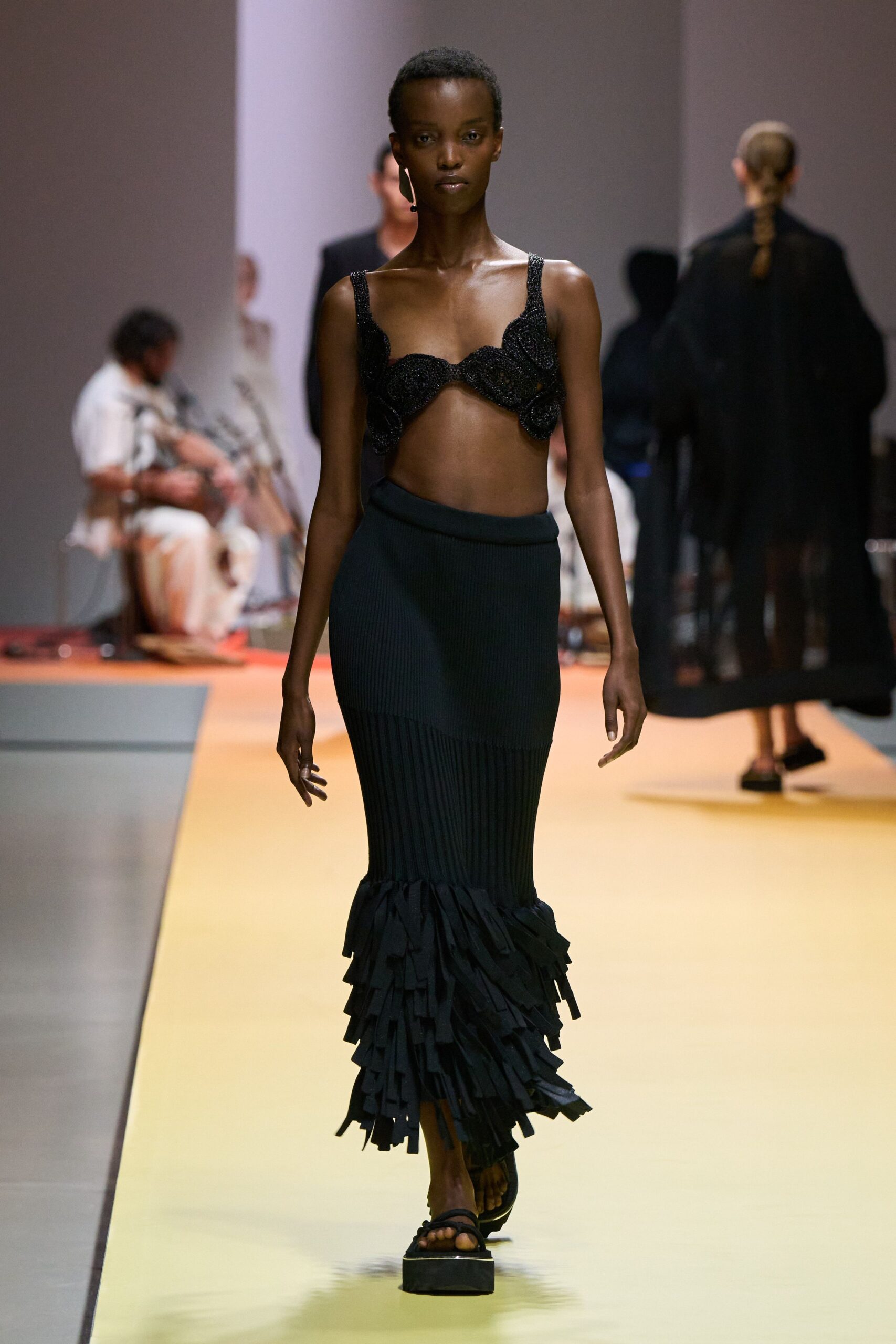black embellished top and fringed skirt