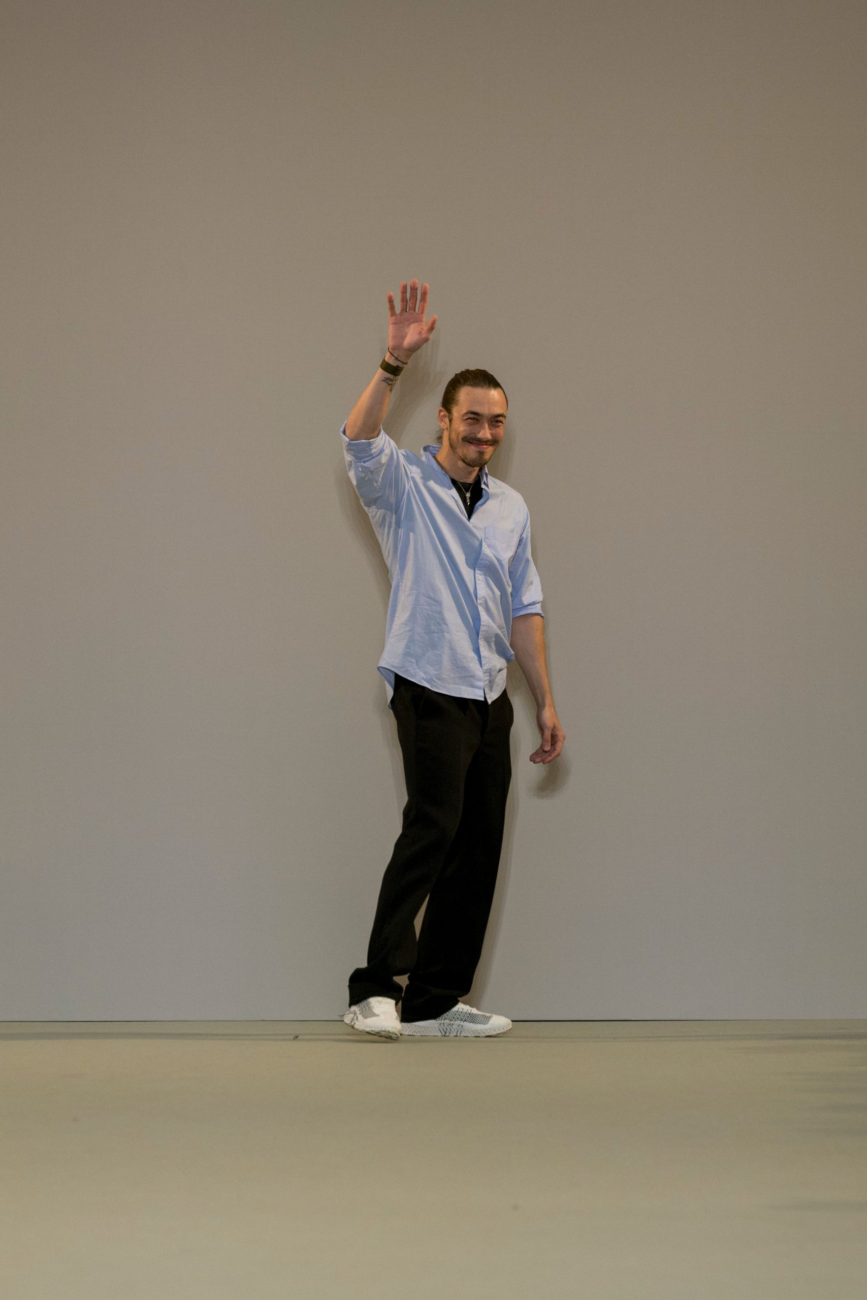 blue shirt black pants white shoes