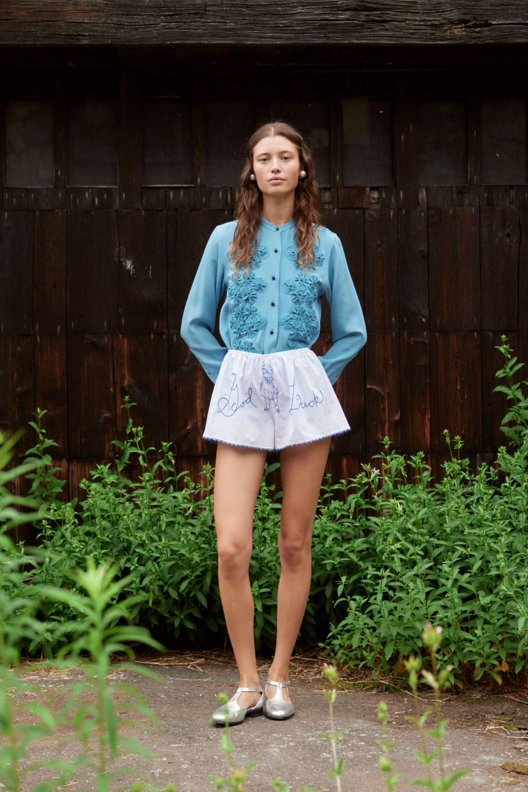 blue embroidered shirt with white shorts