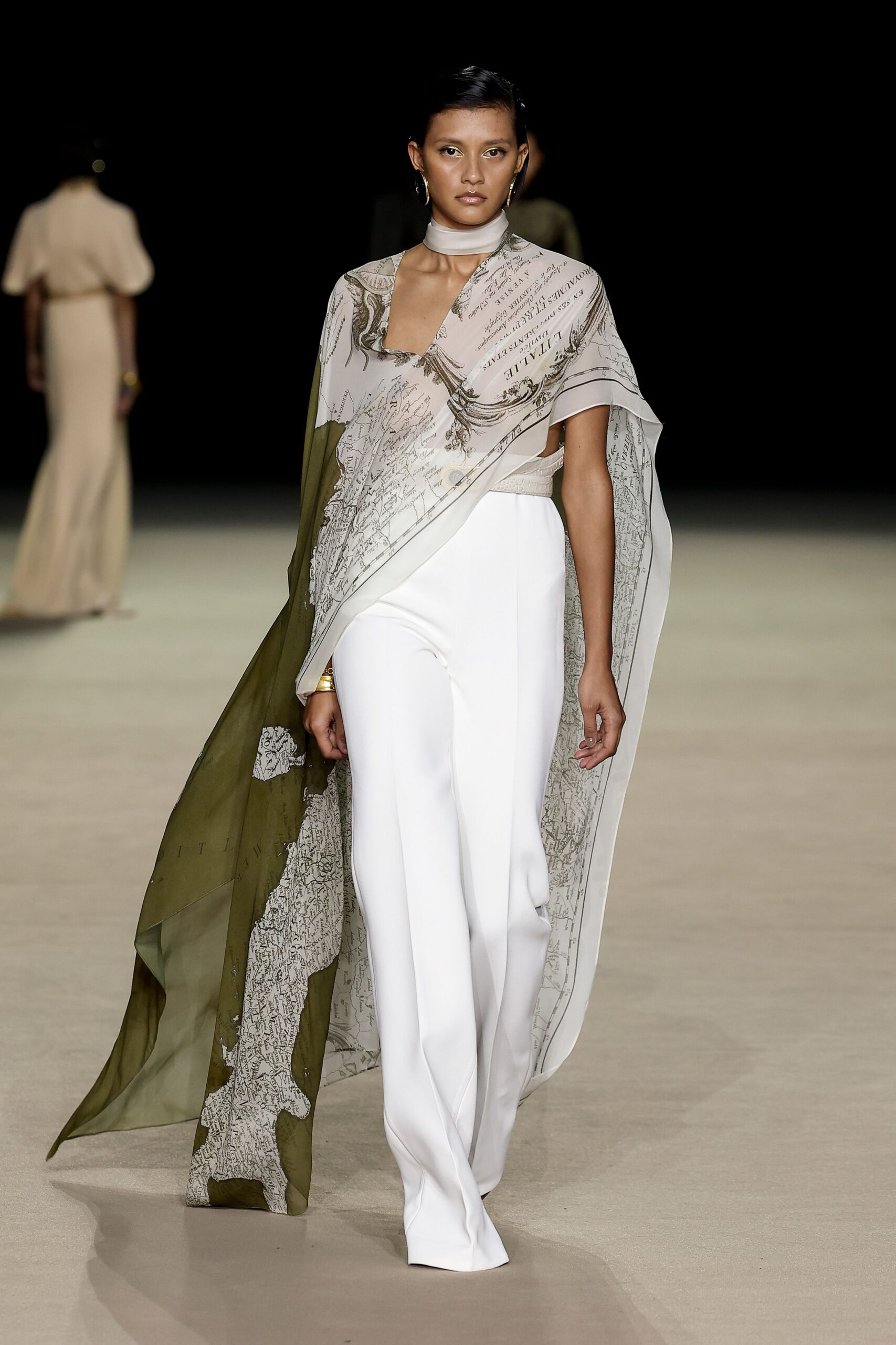 white fitted pants with layered cape