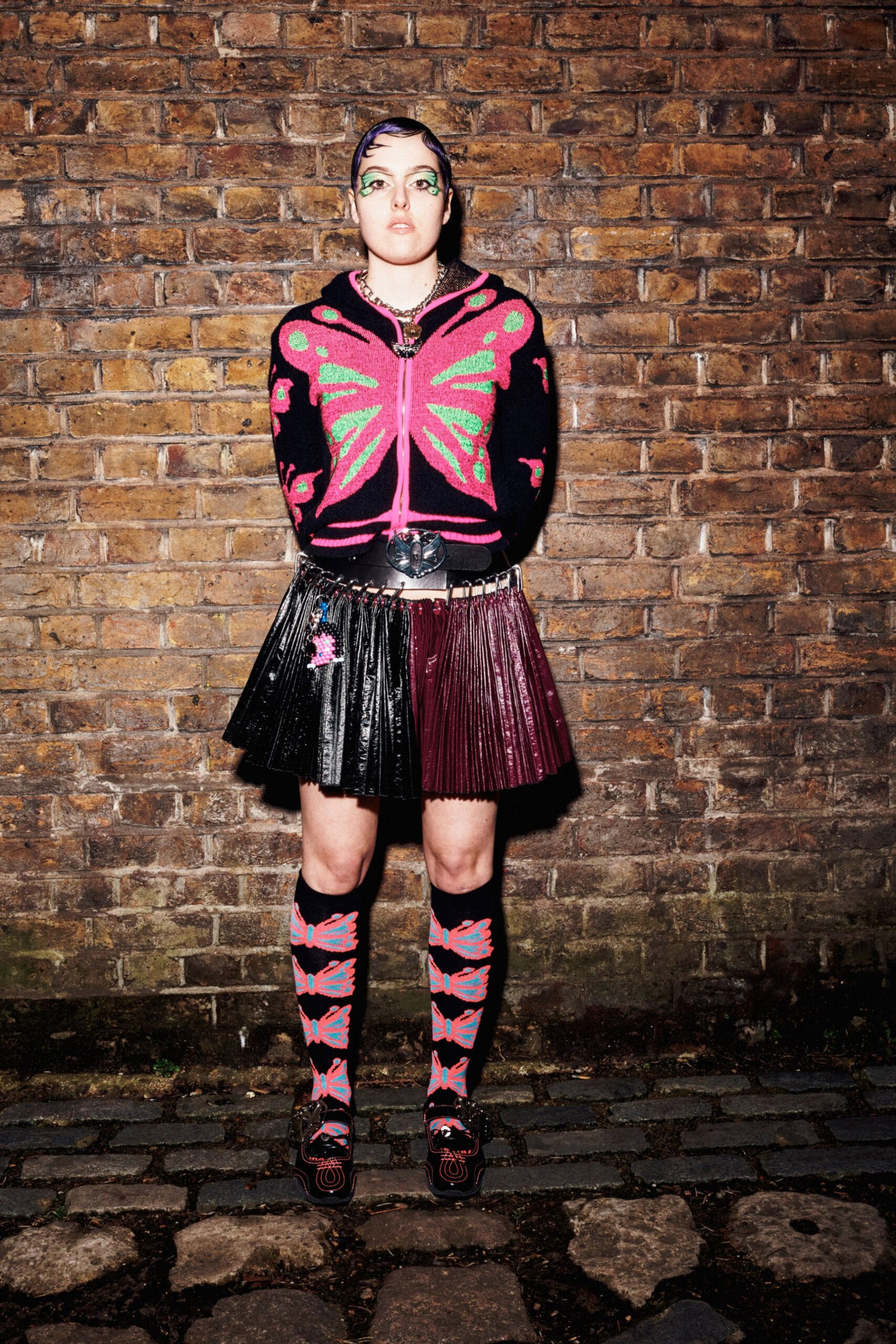 black and pink embroidered cardigan and pleated skirt