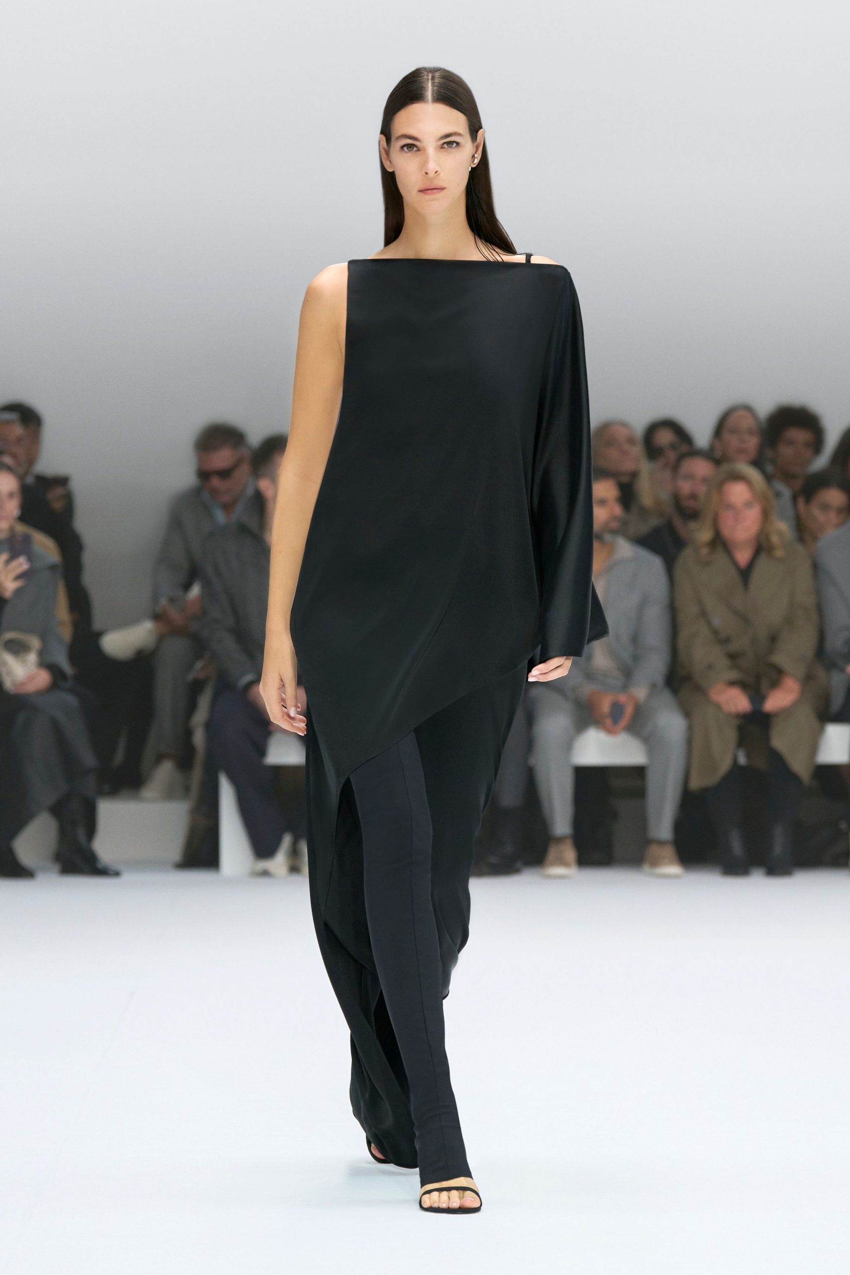 black asymmetric draped dress with strappy shoes