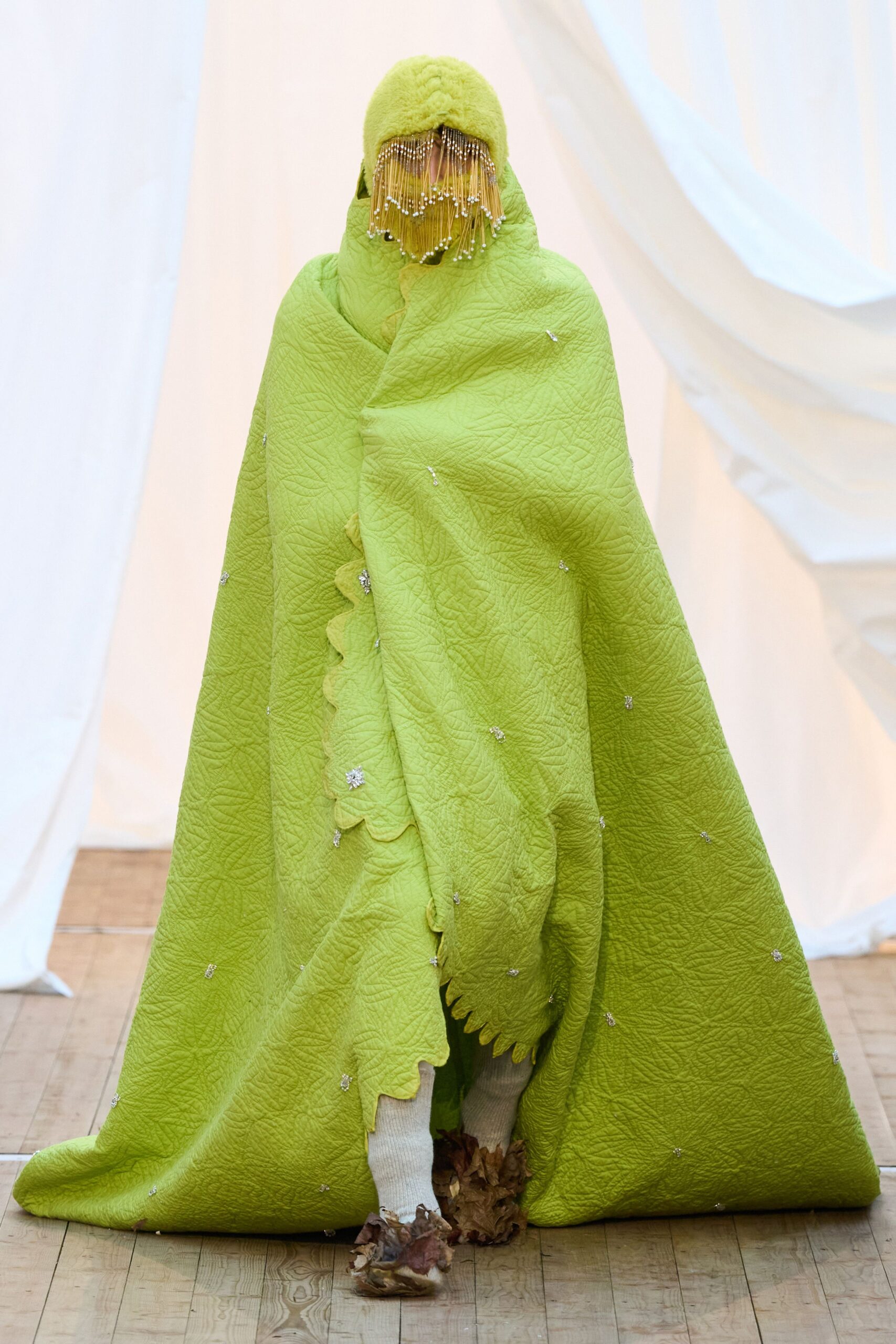 green embroidered cape with distressed shoes