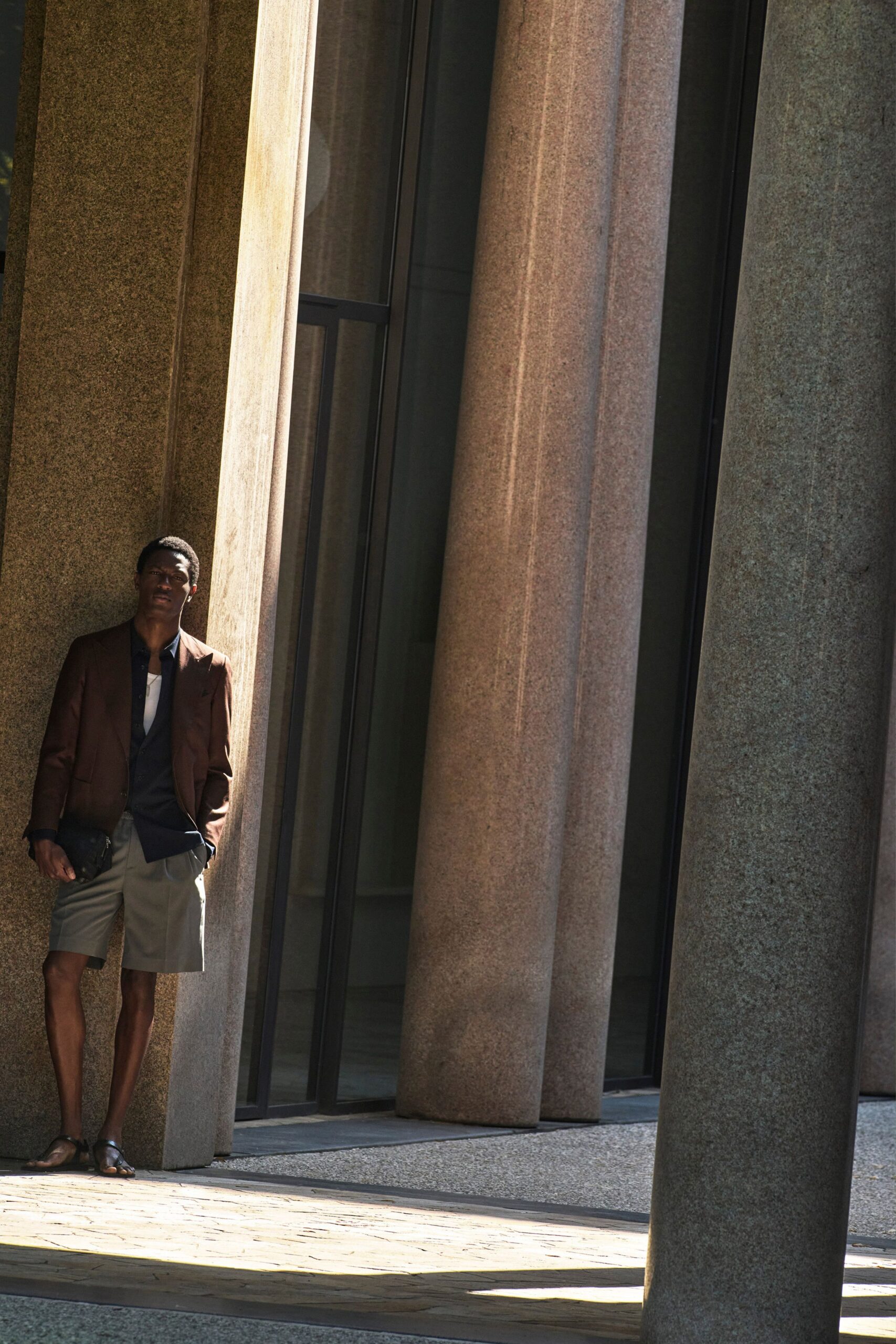 brown blazer blue shirt gray shorts